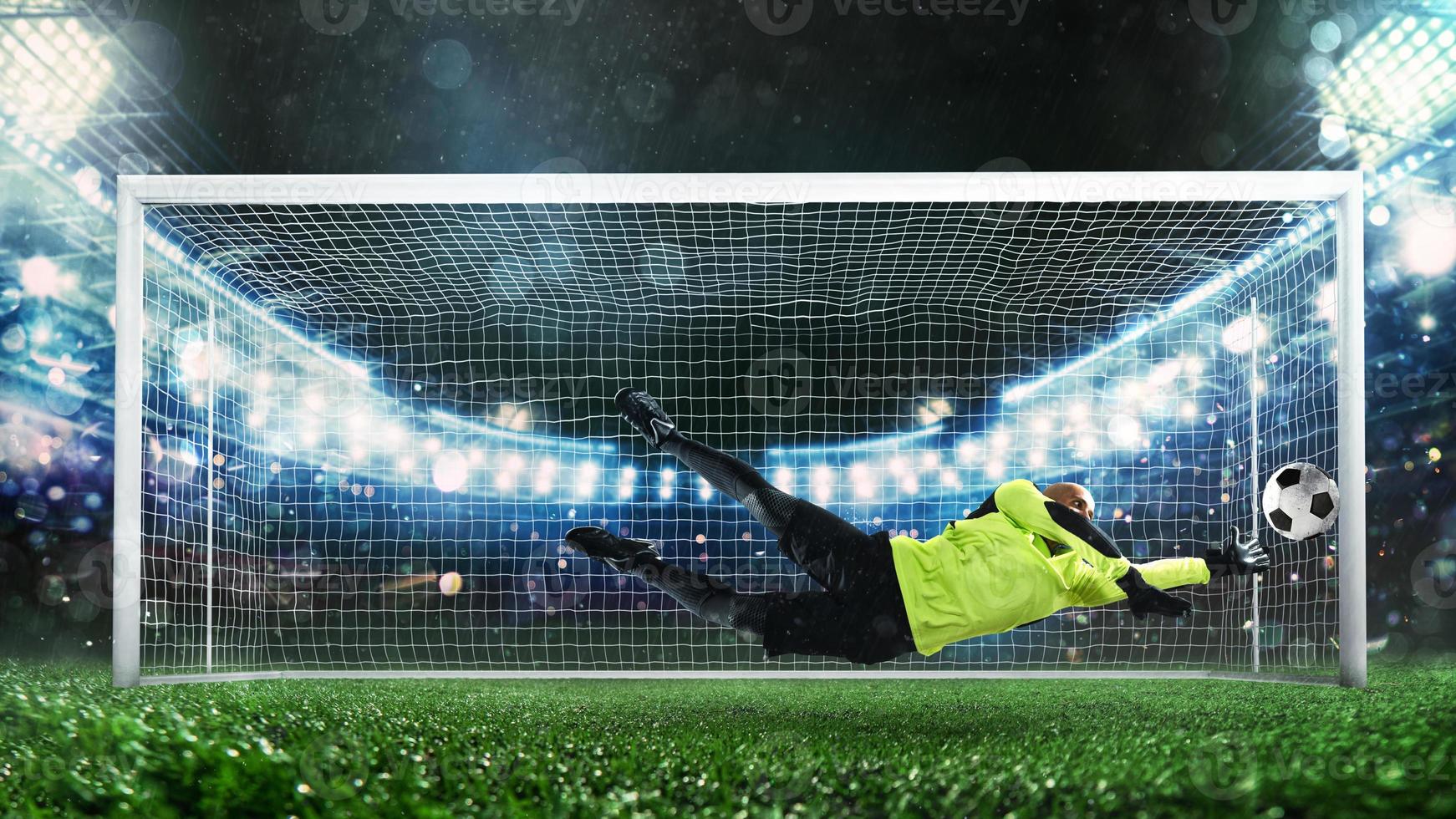 Soccer goalkeeper, in fluorescent uniform, that makes a great save and avoids a goal during a match at the stadium photo