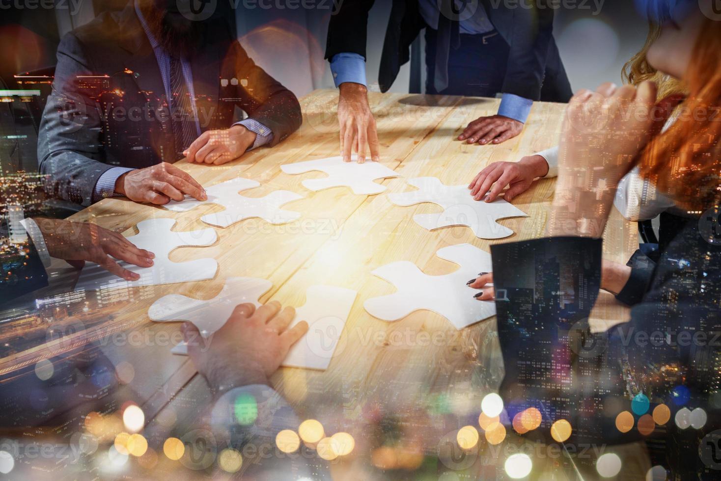 Teamwork of partners connect puzzle pieces as integration and startup photo