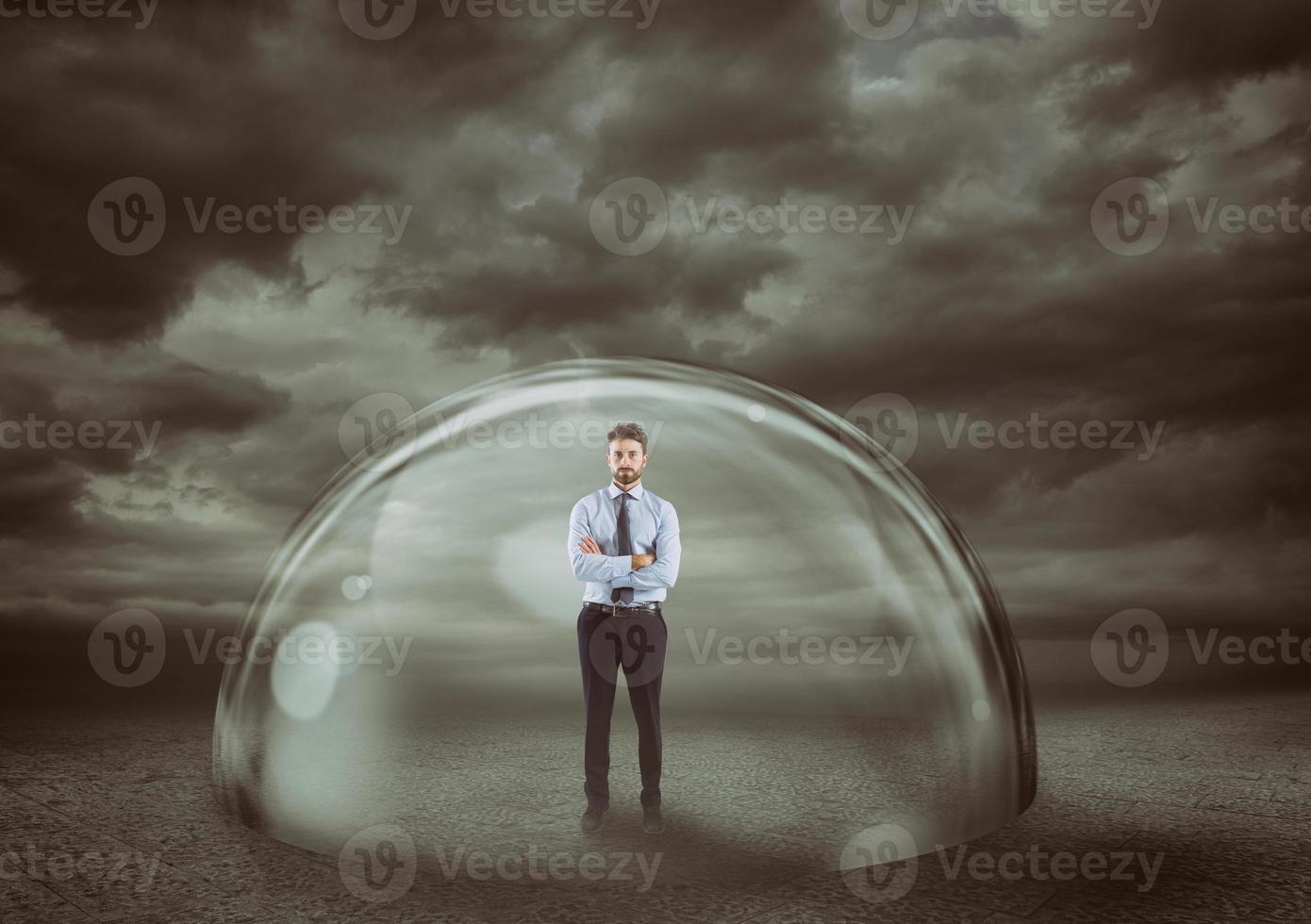 Businessman safely inside a shield dome during a storm that protects him. Protection and safety concept photo