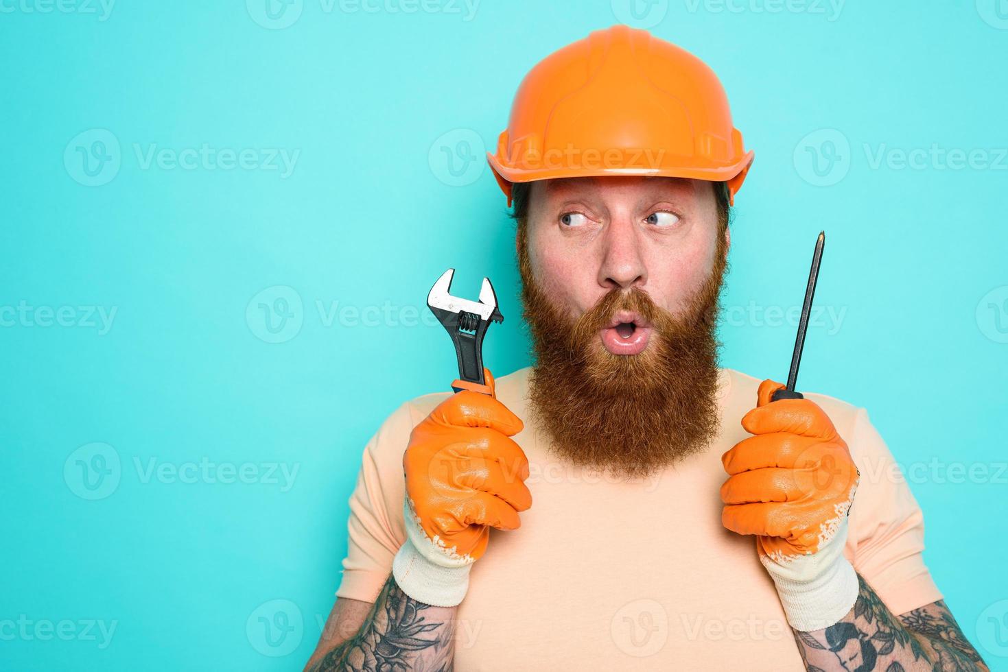 Incompetent worker is unsure about his work. cyan background photo