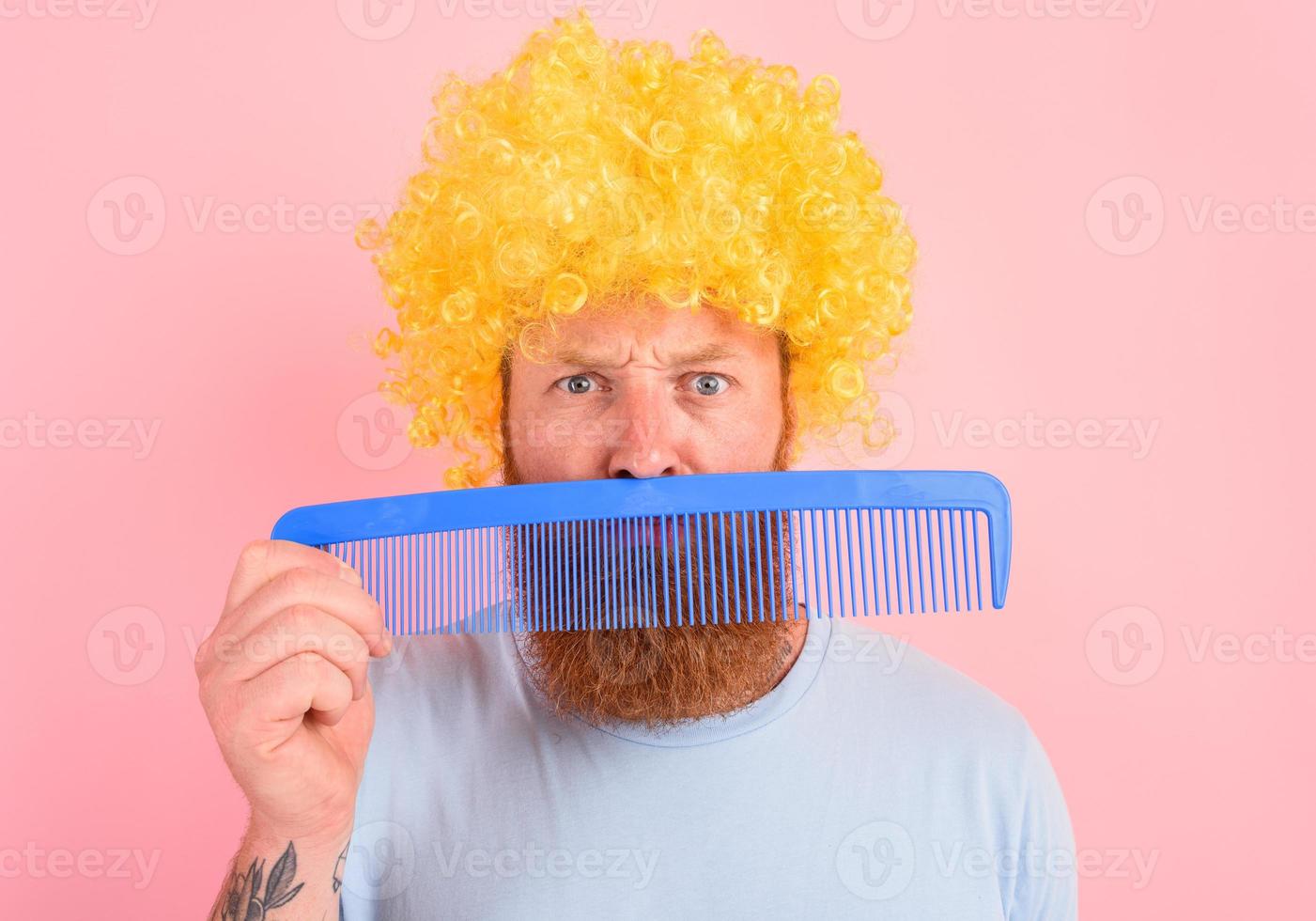 Thoughtful man with beard, yellow peruke and big comb photo