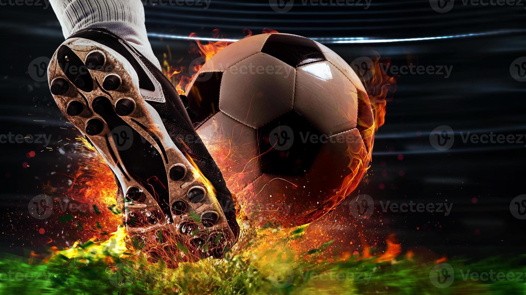 Powerful kick of a soccer player with fiery ball photo