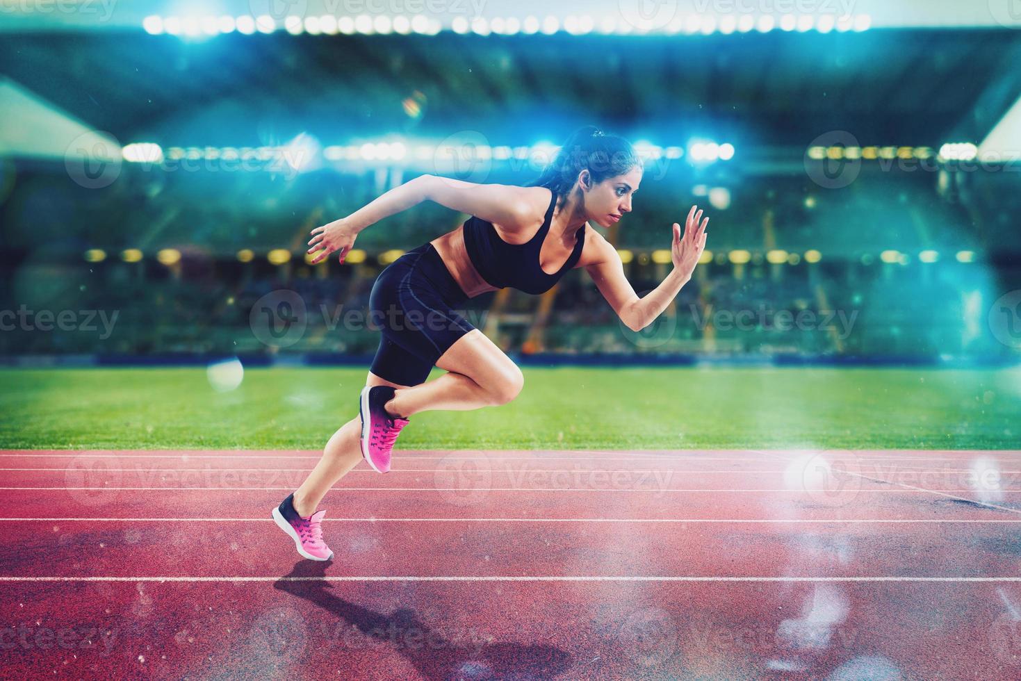 Athletic woman runs in a sport stadium photo