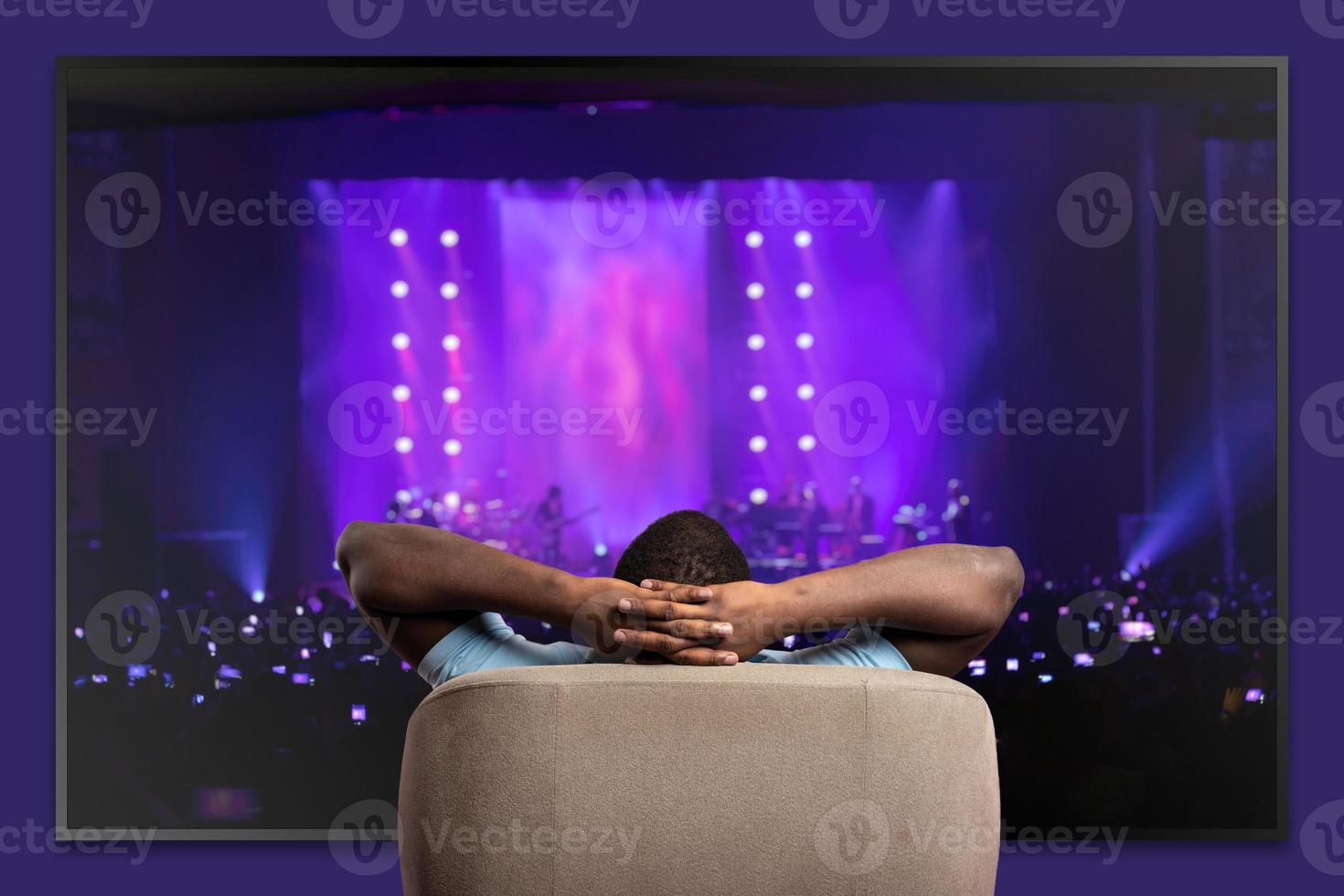 Viewer In Front Of A Large TV Relaxed On The Armchair At Home 20626229 viewer-in-front-of-a-large-tv-relaxed-on-the-armchair-at-home-20626229