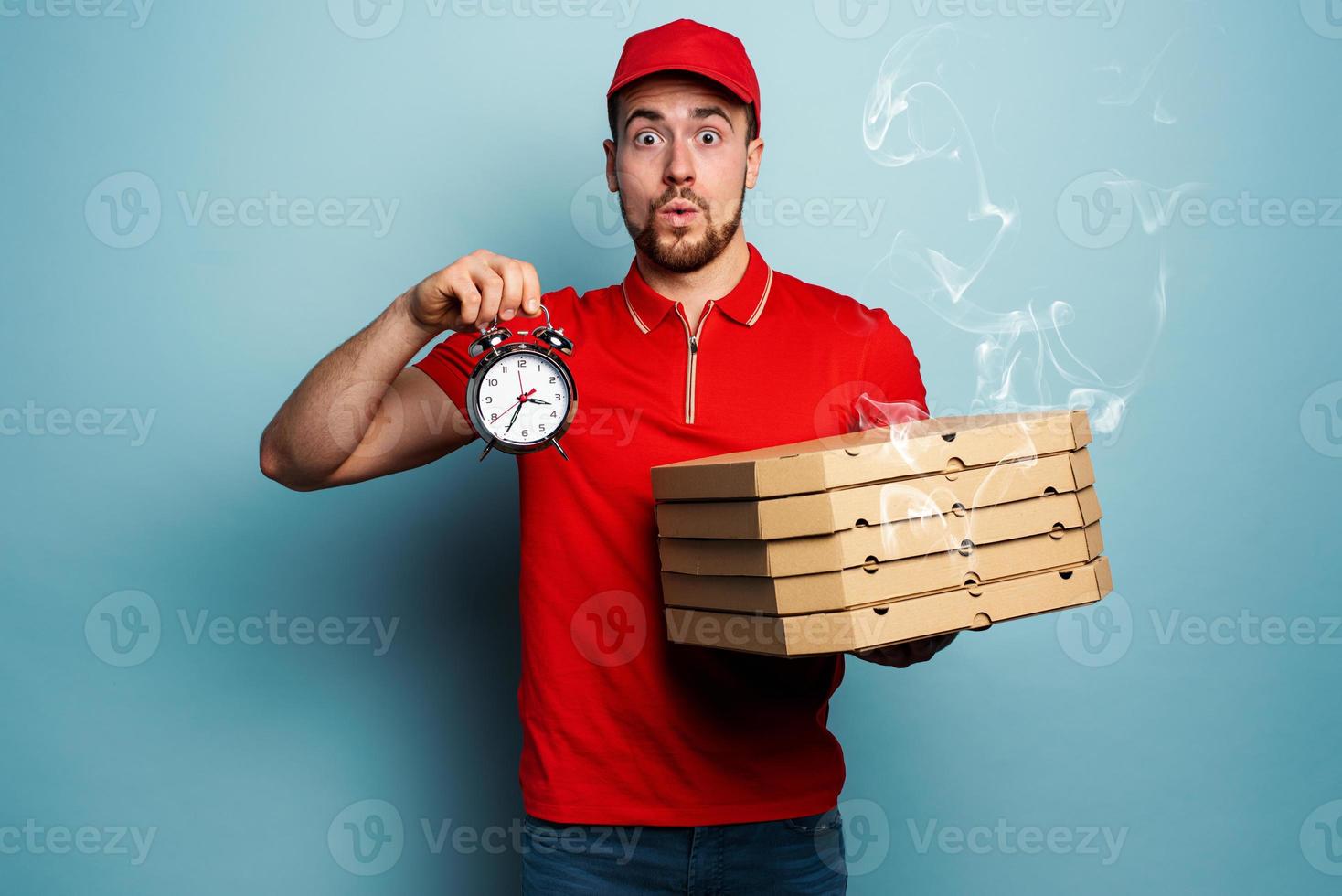 Courier is punctual to deliver quickly pizzas. Cyan background photo