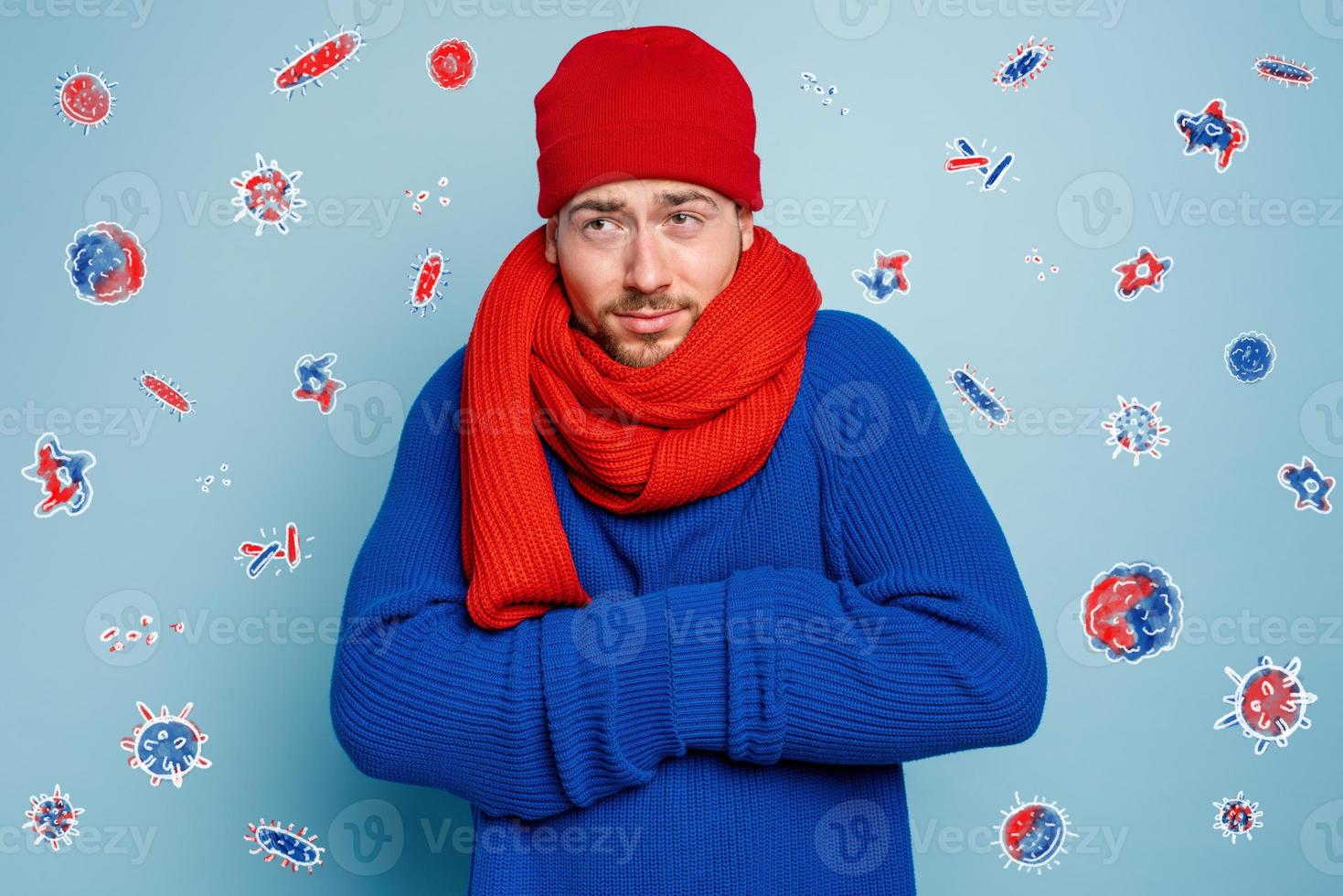 Boy caught a cold and is surrounded by viruses and bacteria. Studio on Cyan background photo