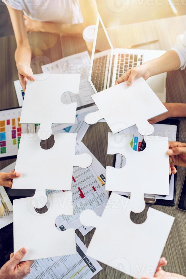 Teamwork of partners connect puzzle pieces as integration and startup photo