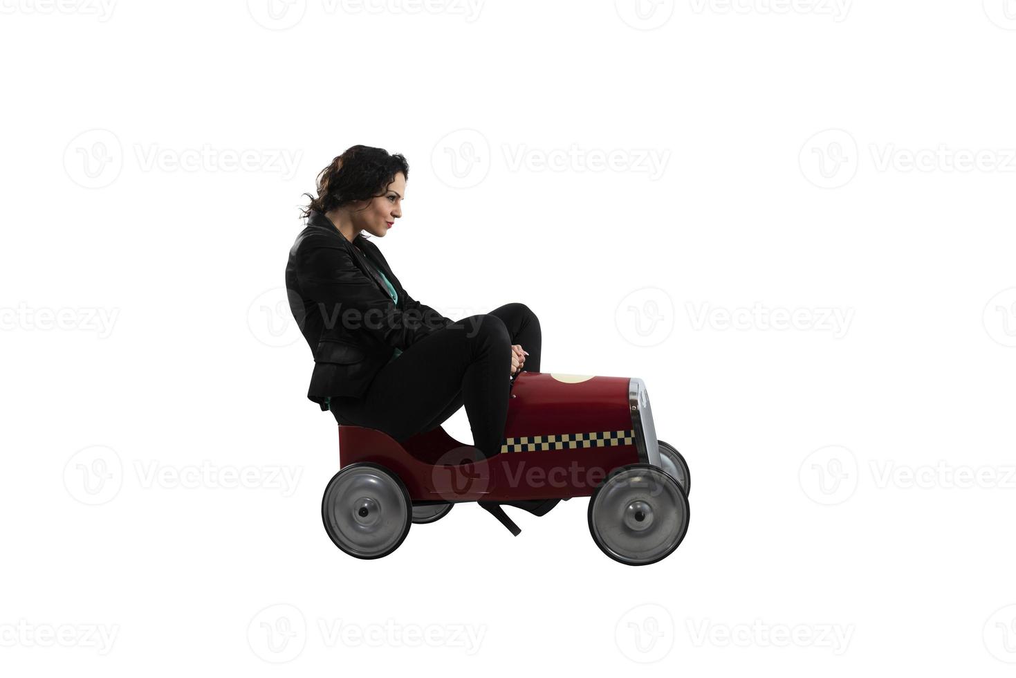Businesswoman drives a toy car. Isolated on white background photo