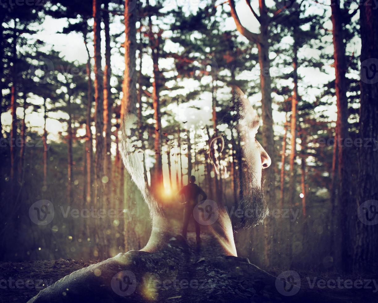 Boy with himself in mind in a forest. Double exposure photo