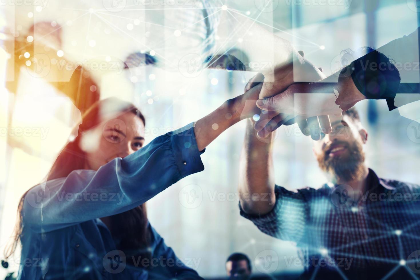 Handshaking business person in office. concept of teamwork and partnership. double exposure with light effects photo