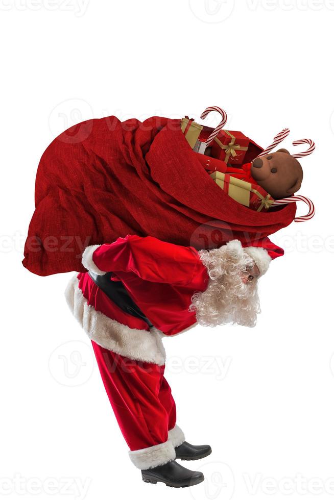 Papa Noel claus llevar un grande saco lleno o Navidad regalos foto