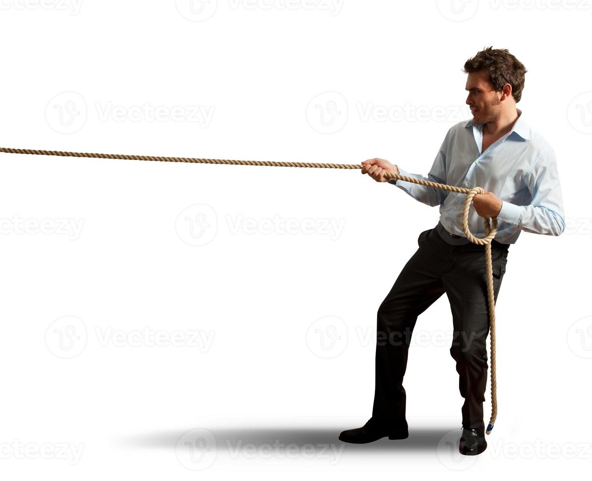 Businessman pulling rope photo