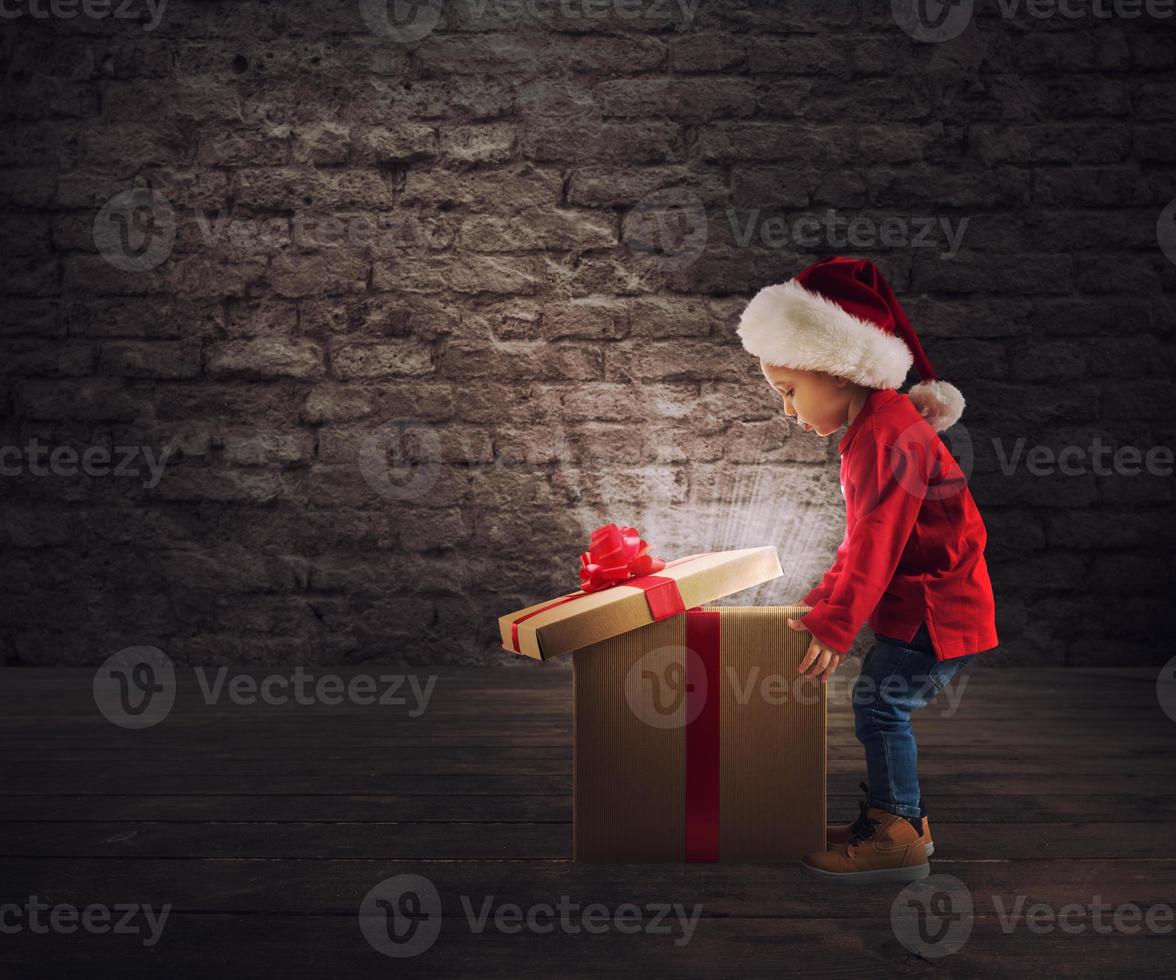 Child that open a magic Christmas gift photo