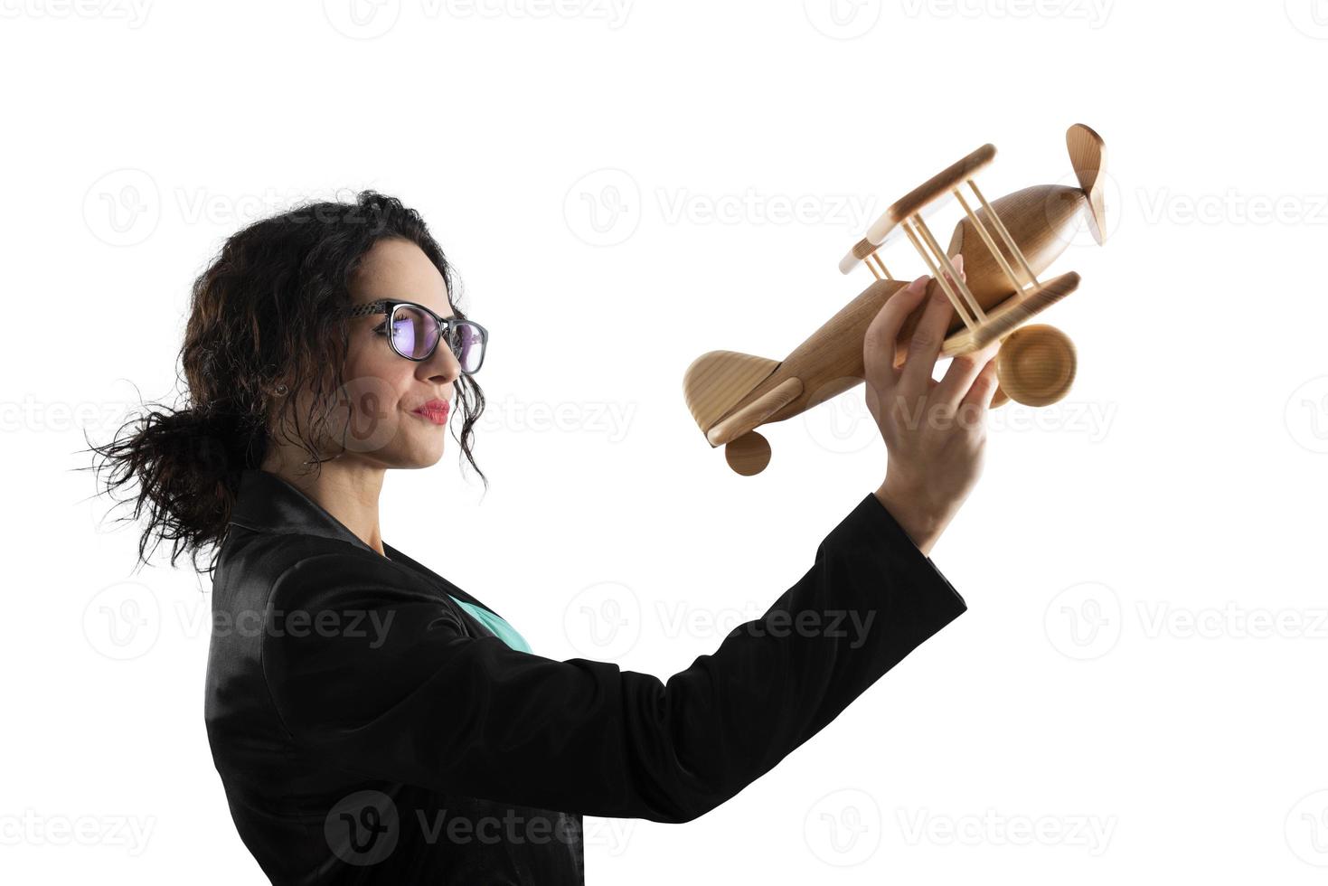 Businesswoman play with a toy aircraft. Concept of company startup and business success. Isolated on white background photo