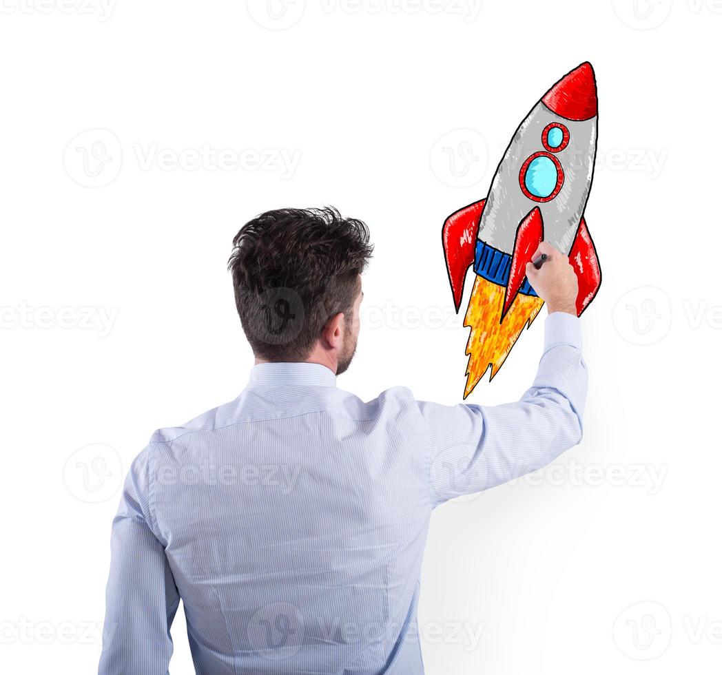 Businessman drawing a rocket. Concept of business improvement and enterprise startup photo