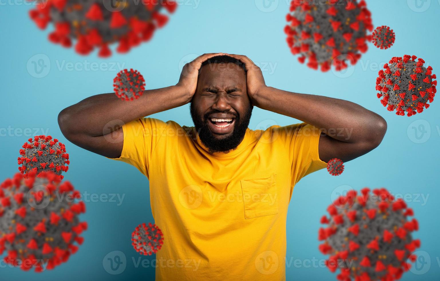 Sad and desperate expression of a boy who is scared to catch the covid-19 coronavirus. Cyan background. photo