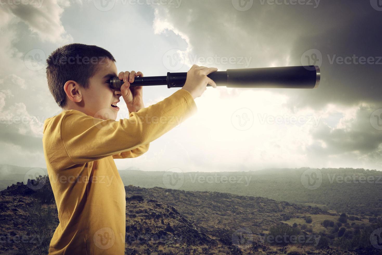 Child with spyglass looks far for a new adventure photo