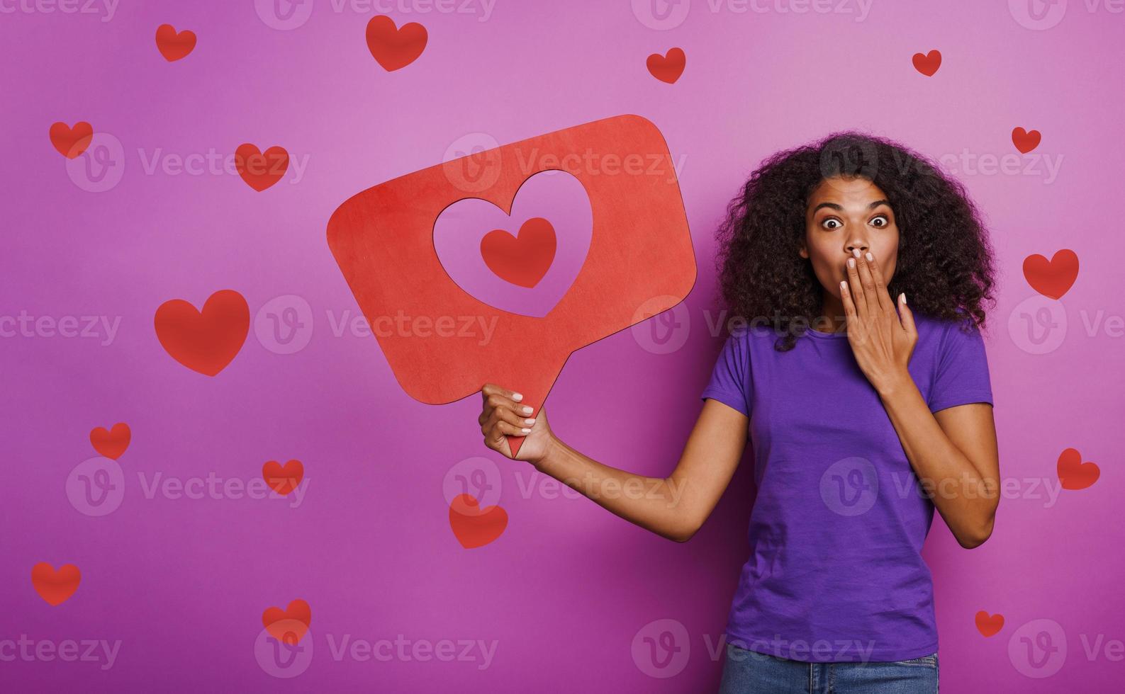 Woman is happy because receives hearts on social network photo
