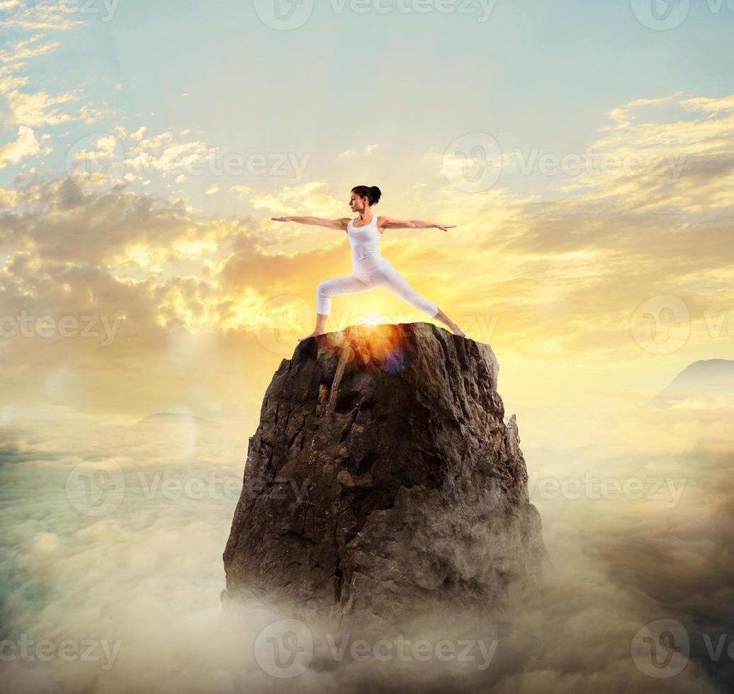 Woman girl is concentrated on doing yoga exercises photo