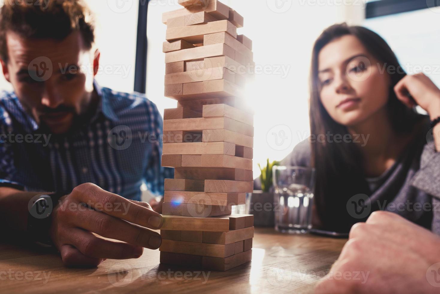 Team of business people build a wooden construction. concept of teamwork ,partnership and company startup photo