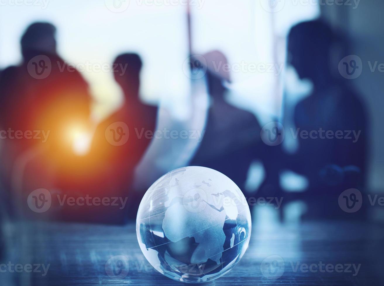 Business concept with glass Earth on a desk photo