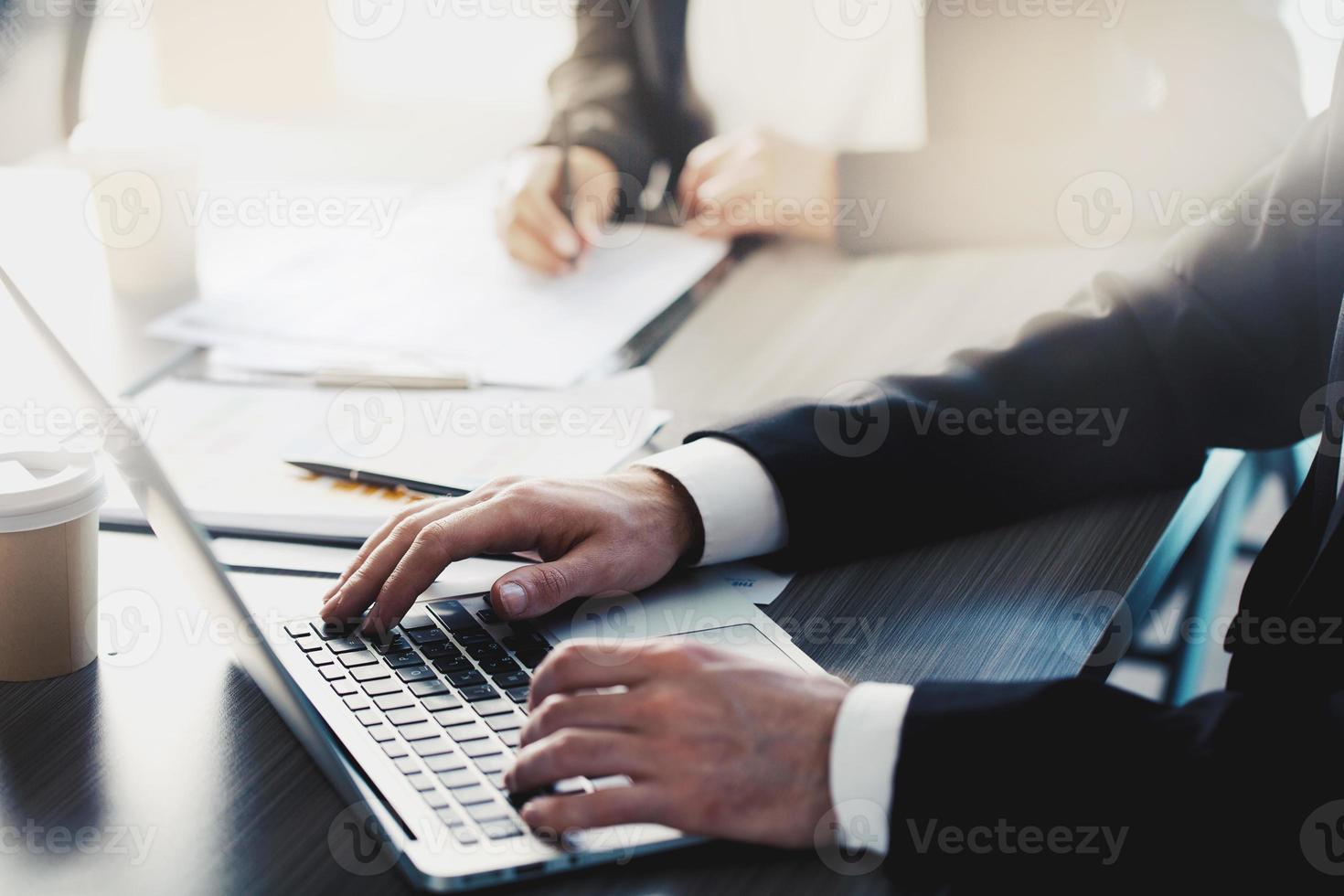 Man working on a laptop in office. Concept of internet sharing and interconnection photo