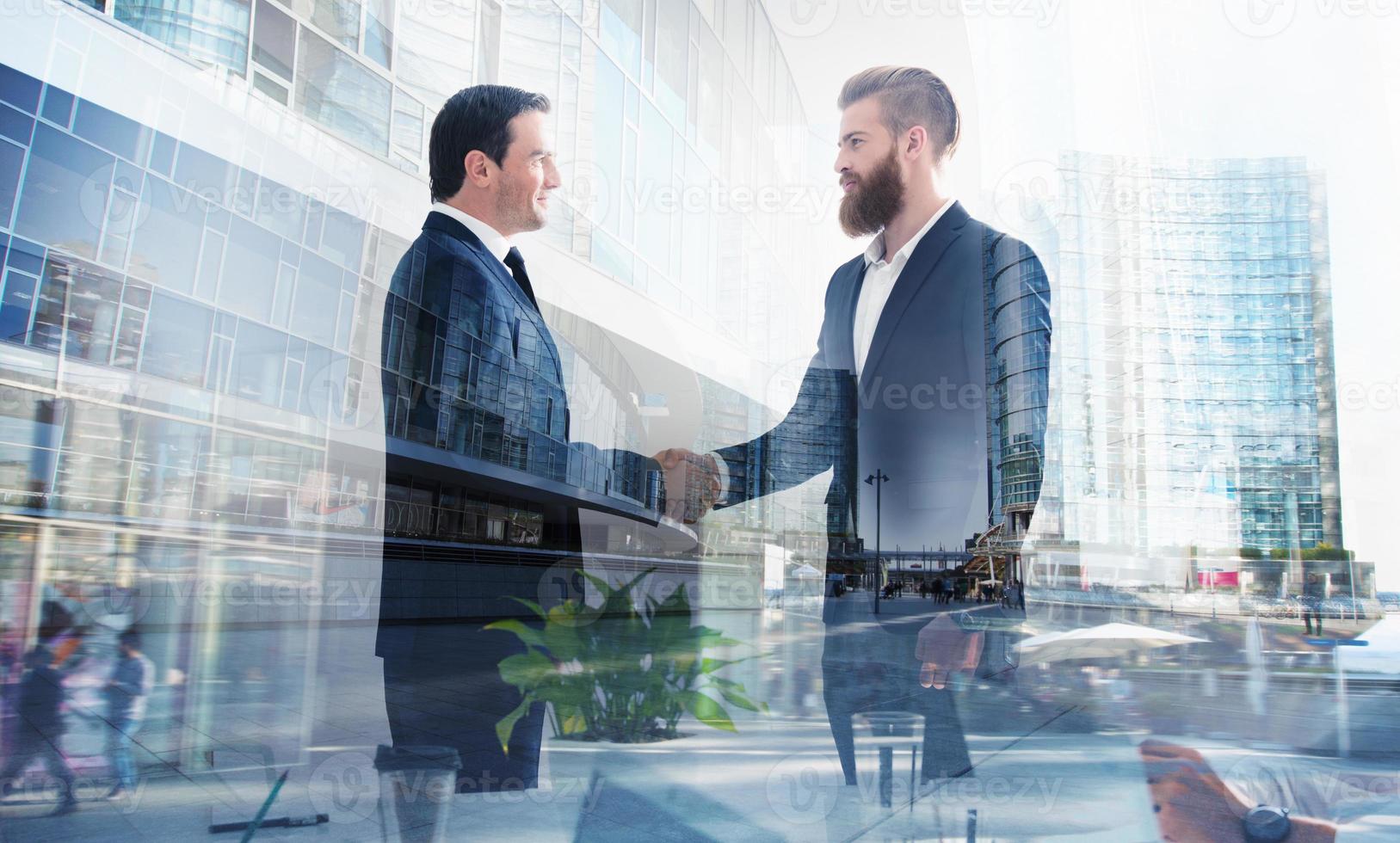 Handshaking business person in office. concept of teamwork and partnership. double exposure photo