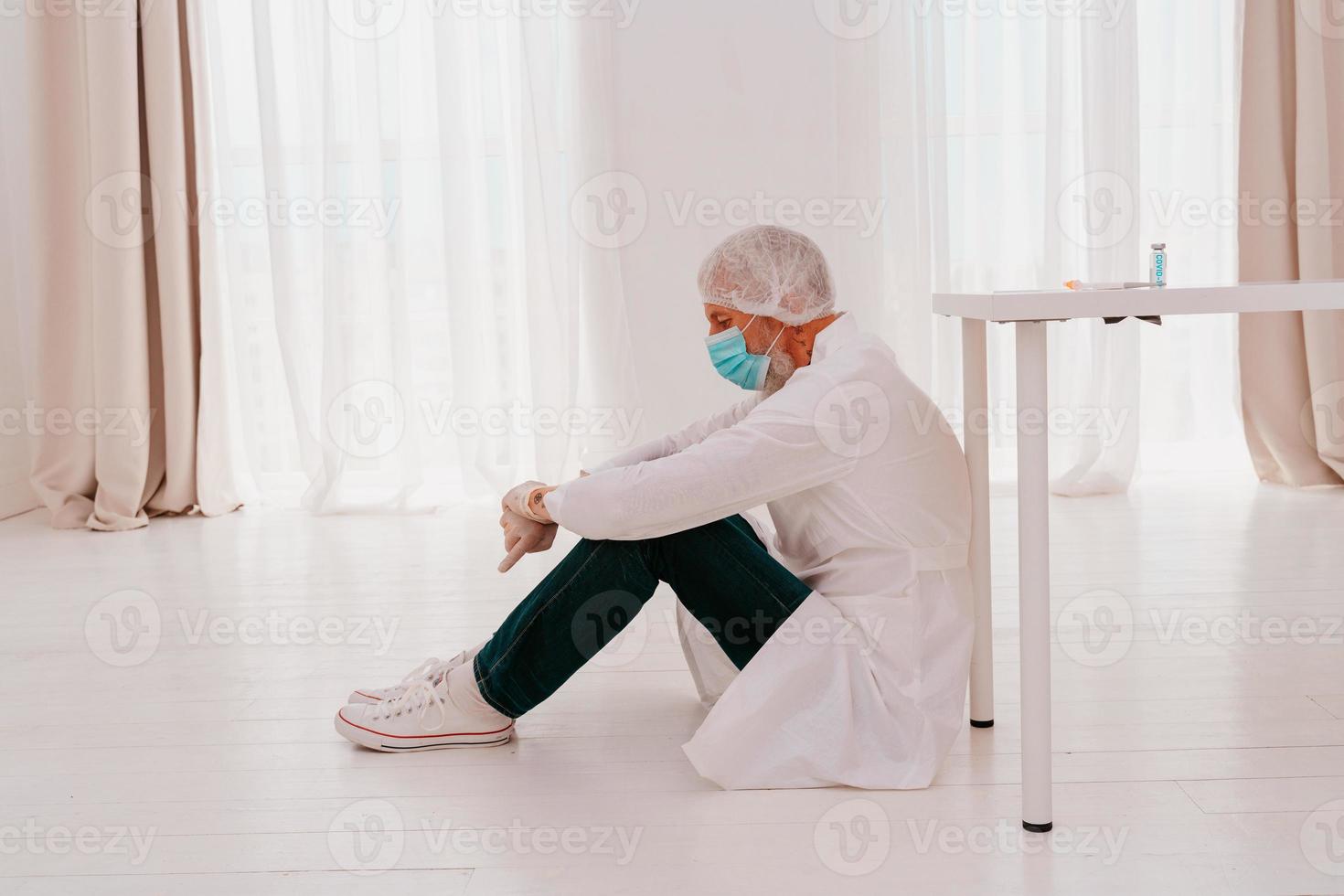 doctor is tired and stressed due to covid-19 virus pandemic photo