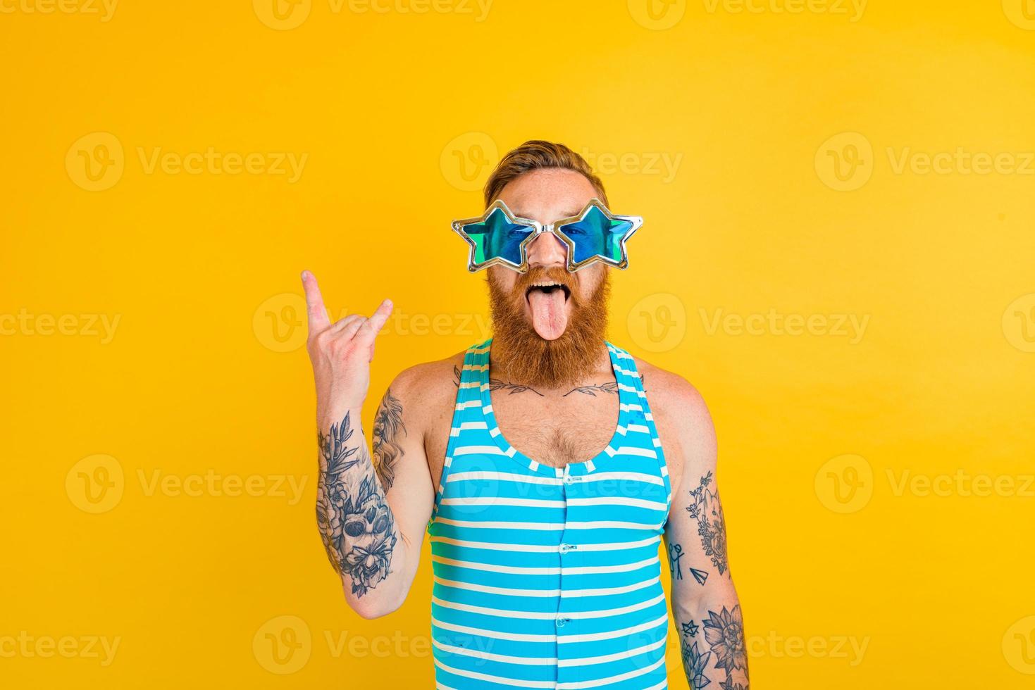 man with beard,tattoos and swimsuit is ready for the summer photo