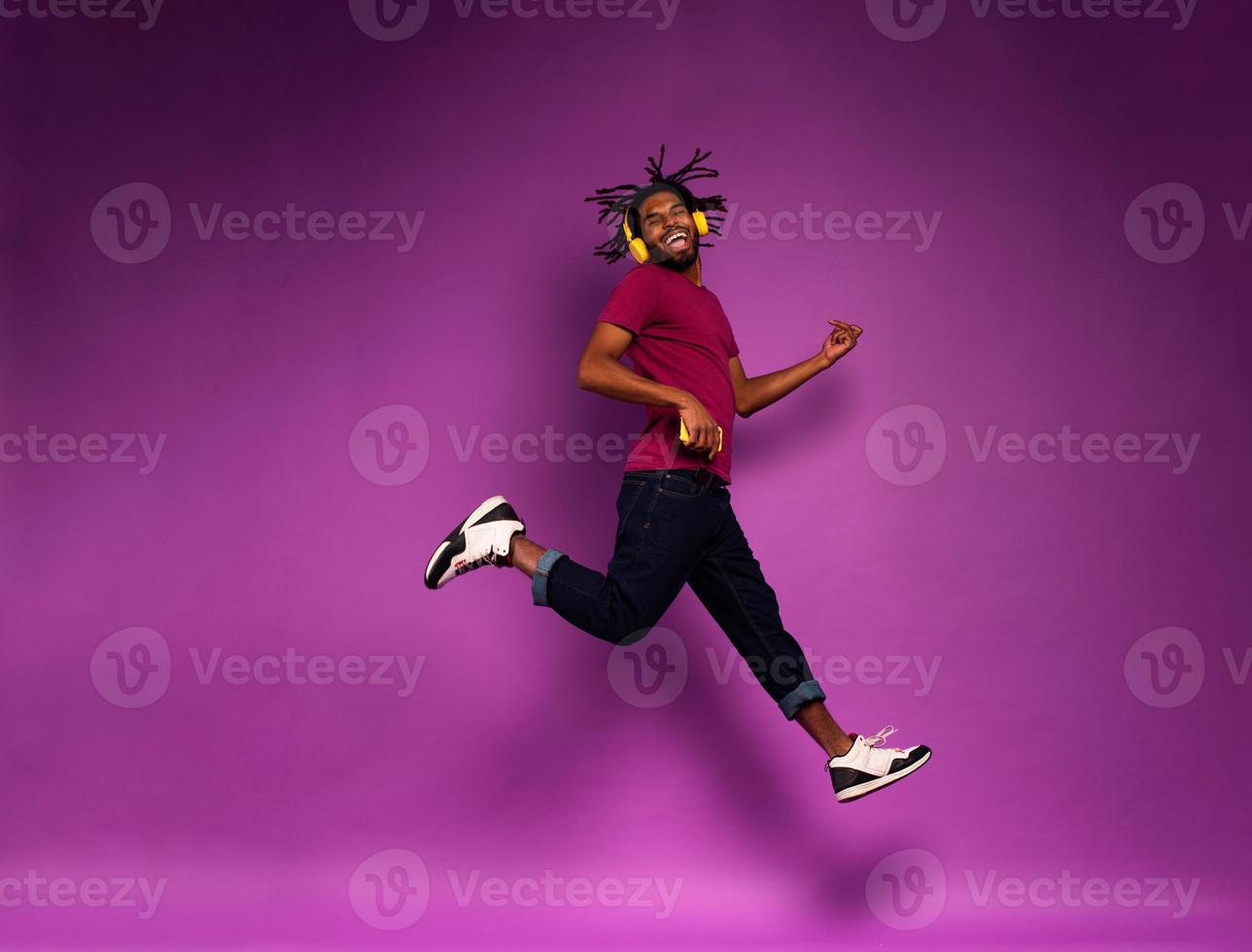 Boy with yellow headset listens to music and dances. emotional and energetic expression photo