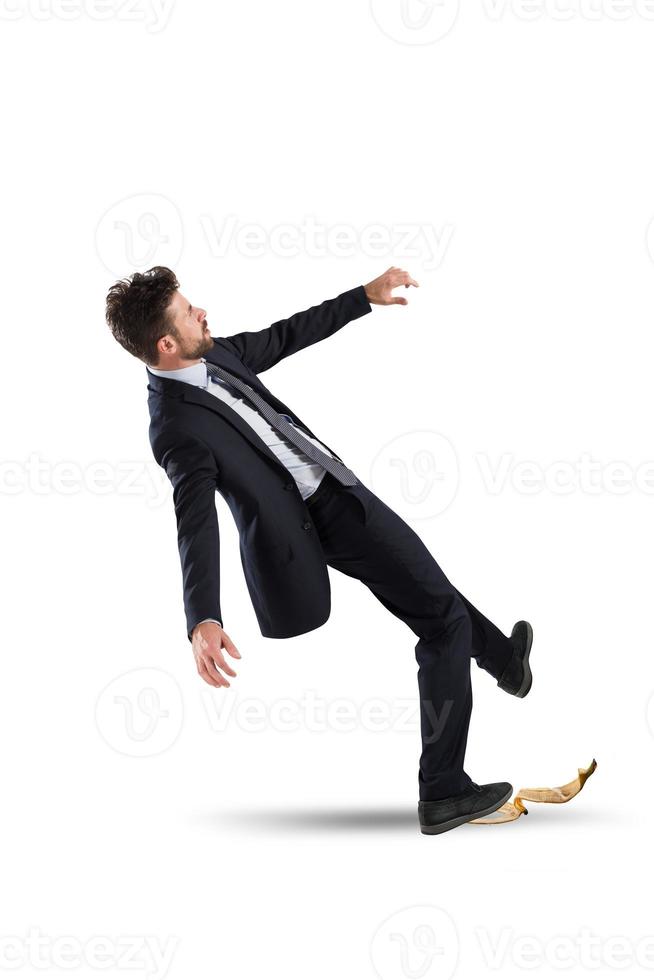 Businessman slips on a banana peel. concept of unlucky and failure photo