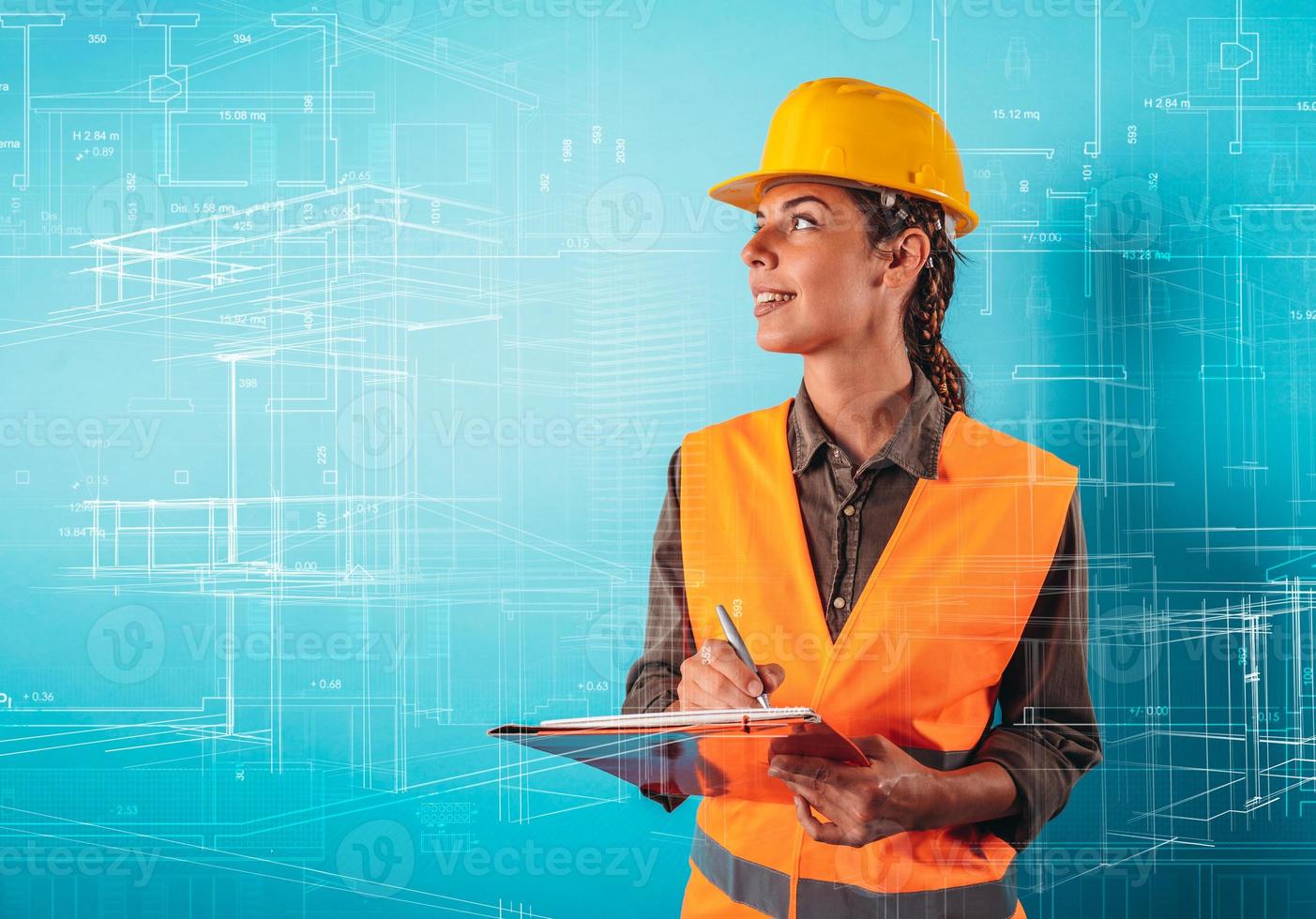 Confident woman architect with an orange helmet does a sketch photo