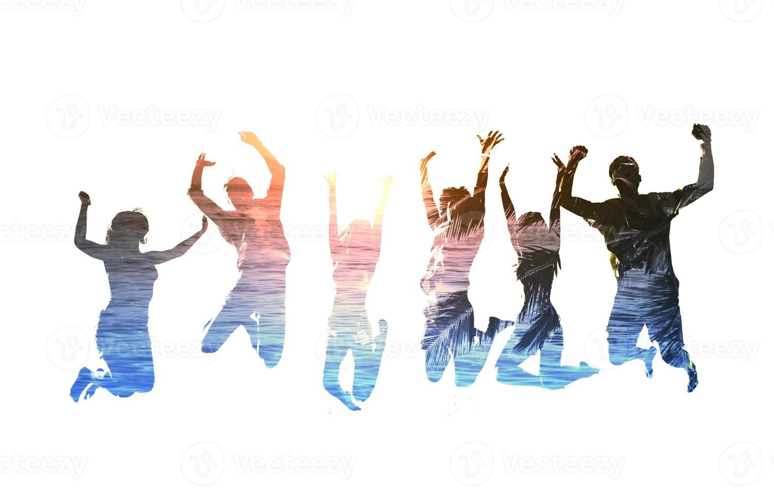 Silhouette of jumping friends with background of the beach photo