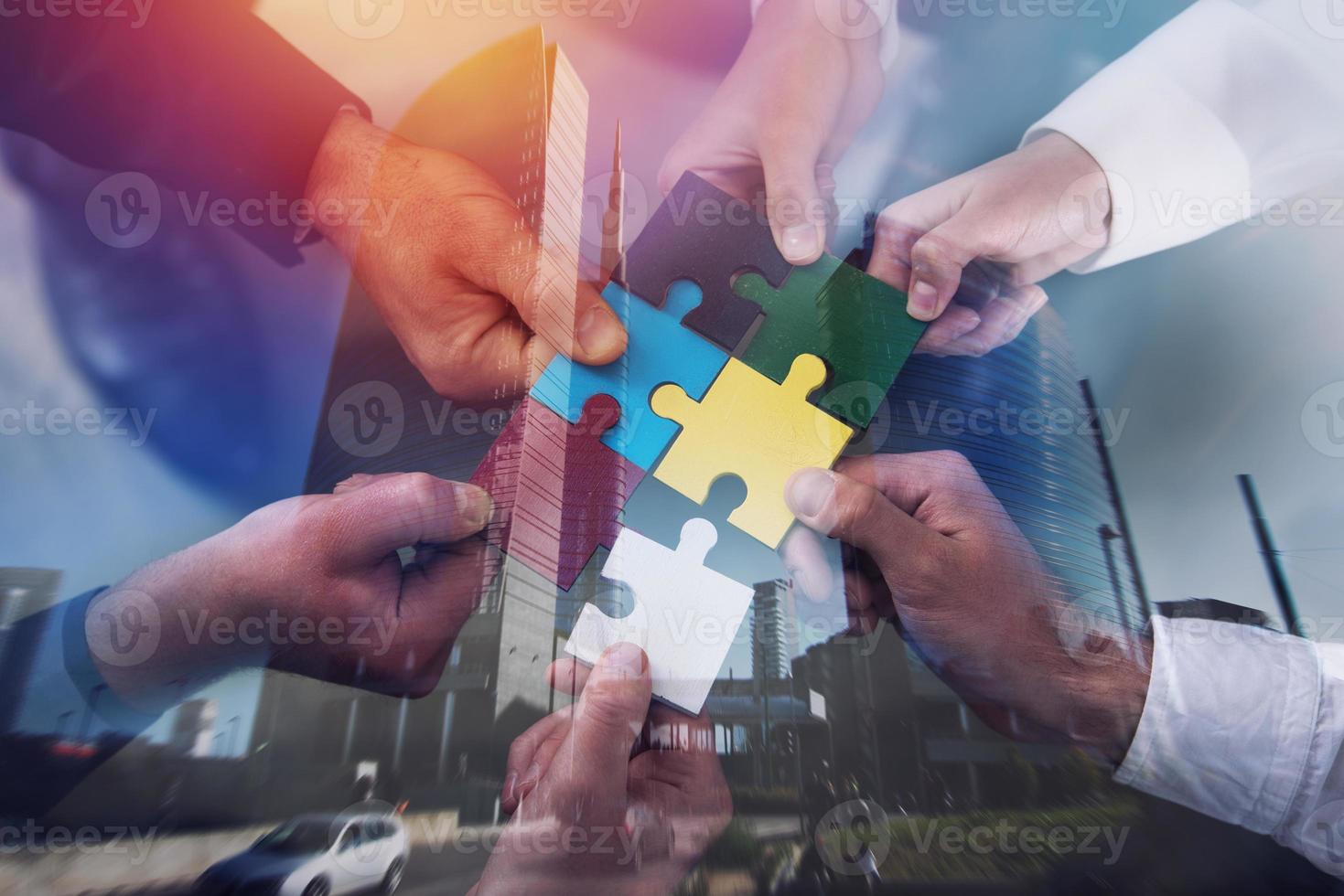 Teamwork of partners. Concept of integration and startup with puzzle pieces. double exposure photo