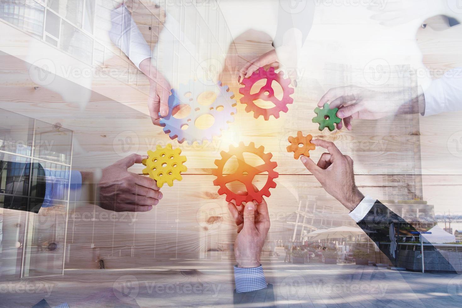Business team connect pieces of gears. Teamwork, partnership and integration concept. double exposure photo