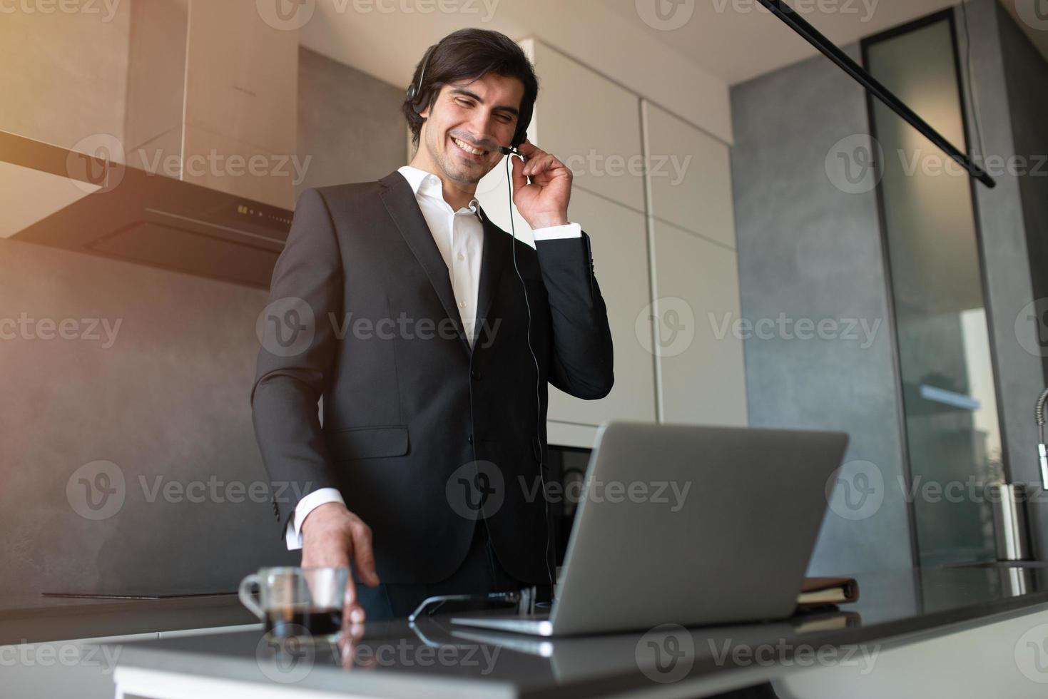 Businessman works from remote at house with a laptop due to coronavirus quarantine. photo