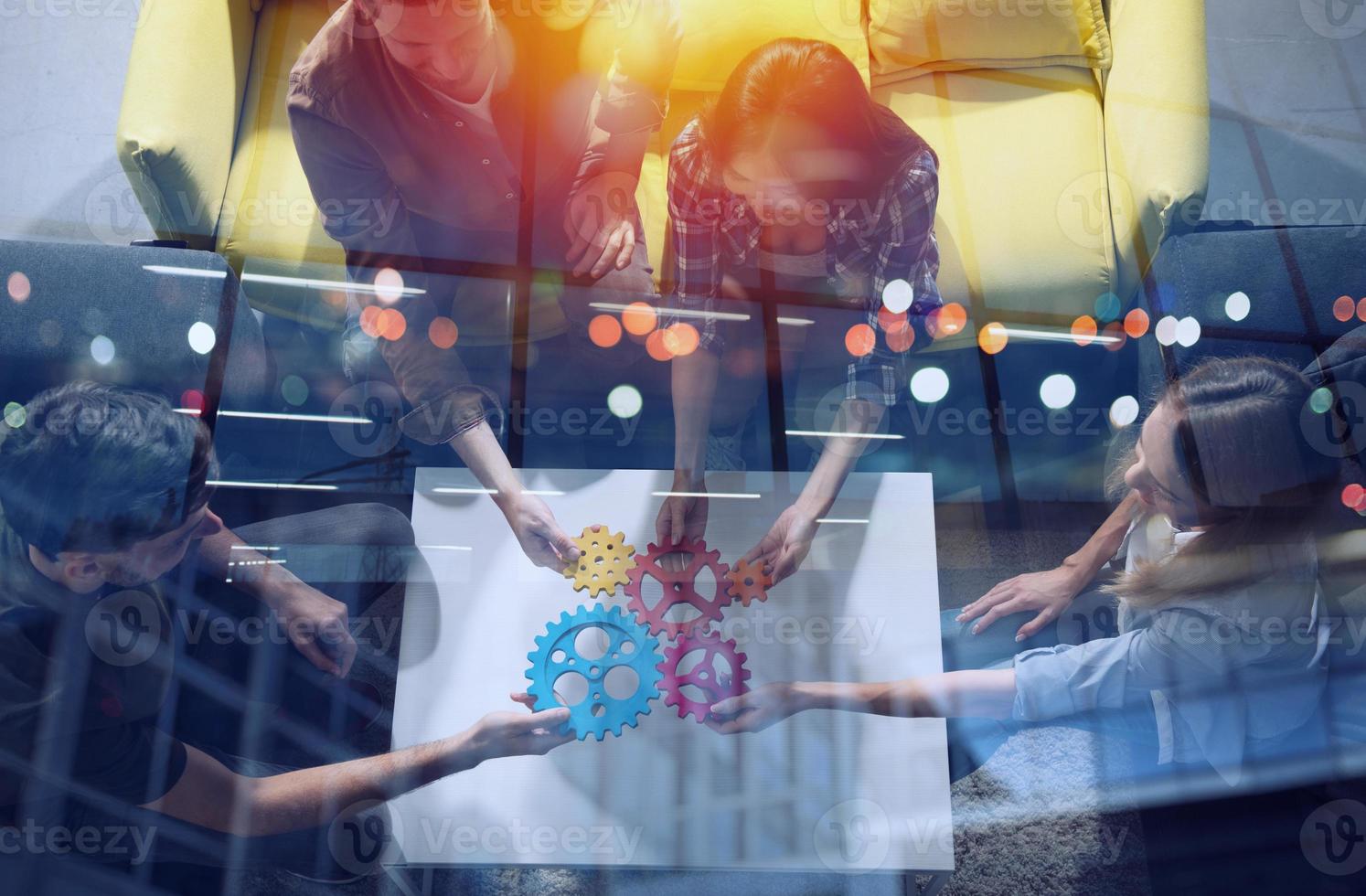 Business team connect pieces of gears. Teamwork, partnership and integration concept photo