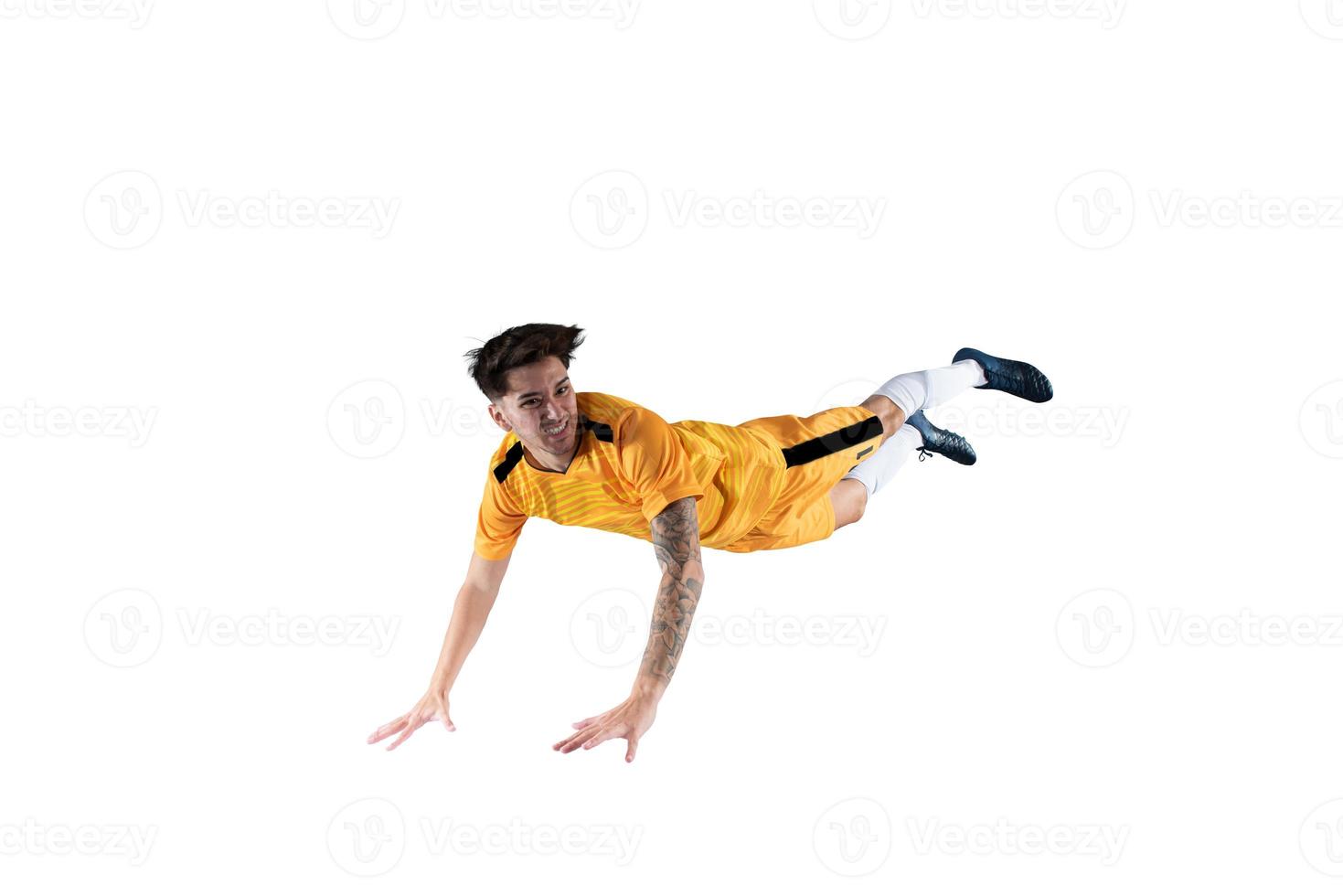 Football striker player with yellow team suit jumps photo