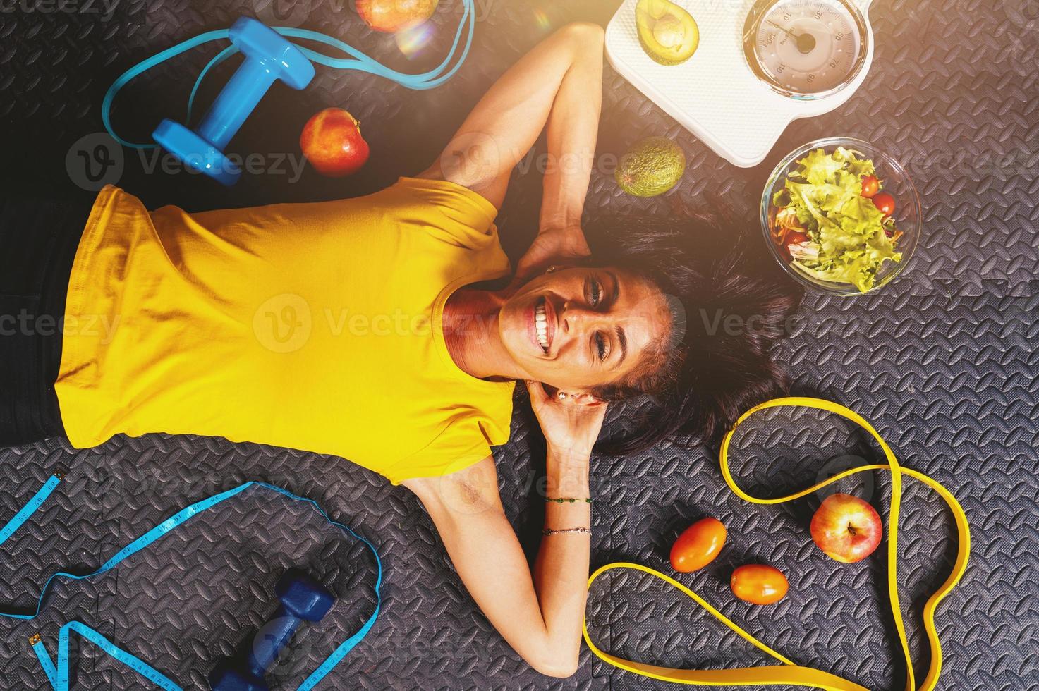 Happy woman does exercises with elastic at the gym photo