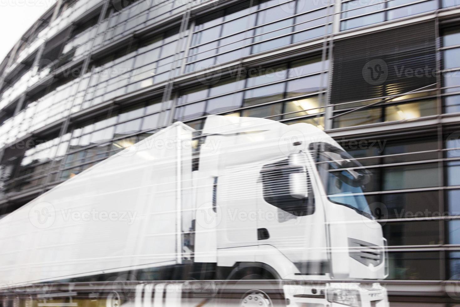 Fast truck reflected on a skyscraper. double exposure photo