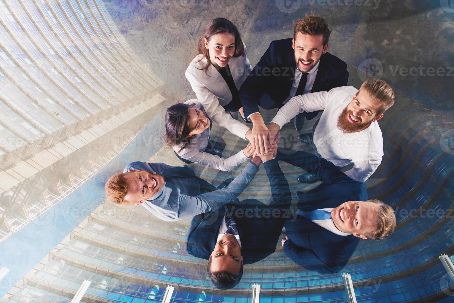 Business people putting their hands together. Concept of integration, teamwork and partnership. double exposure photo
