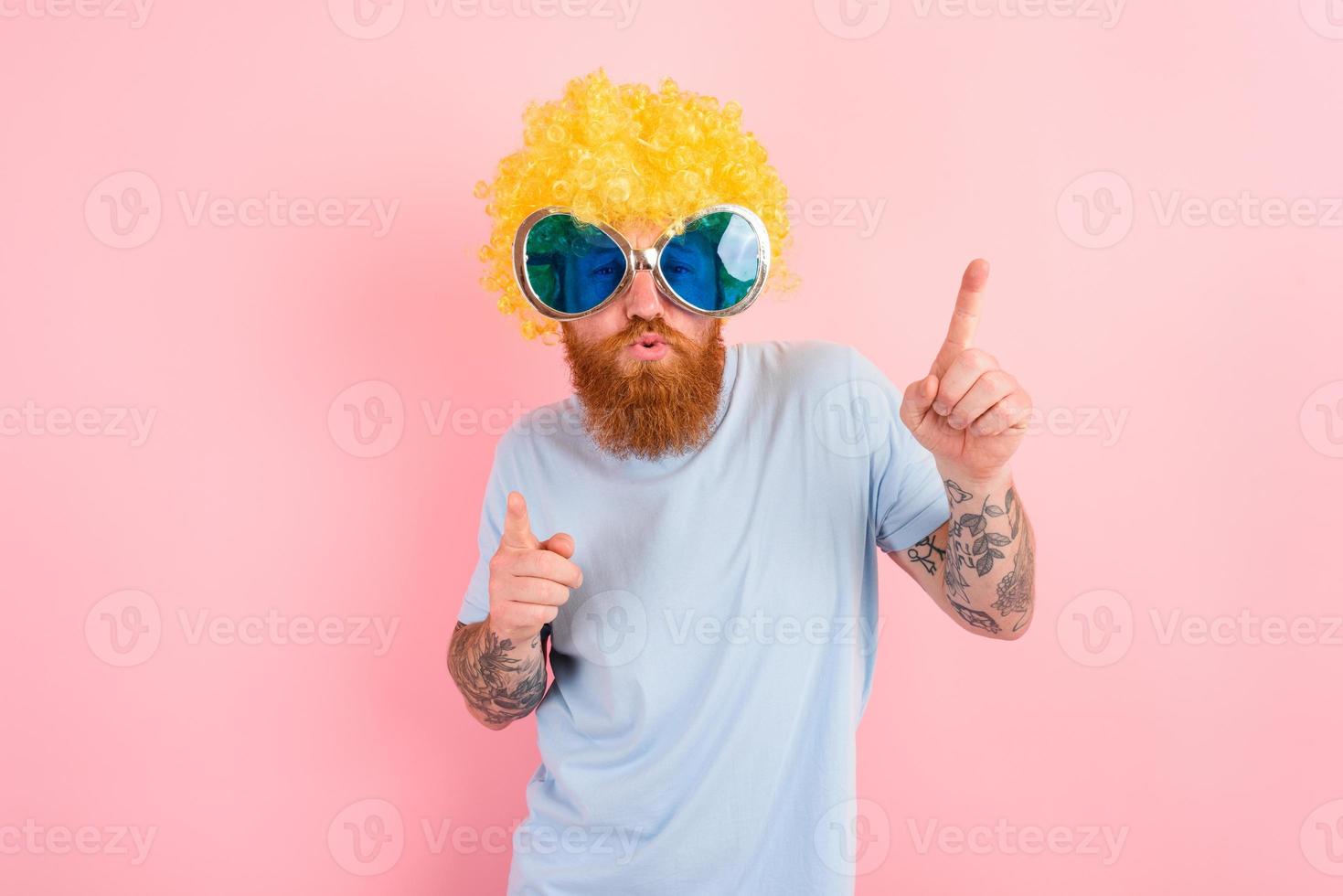 Funny man with peruke and sunglasses dances photo