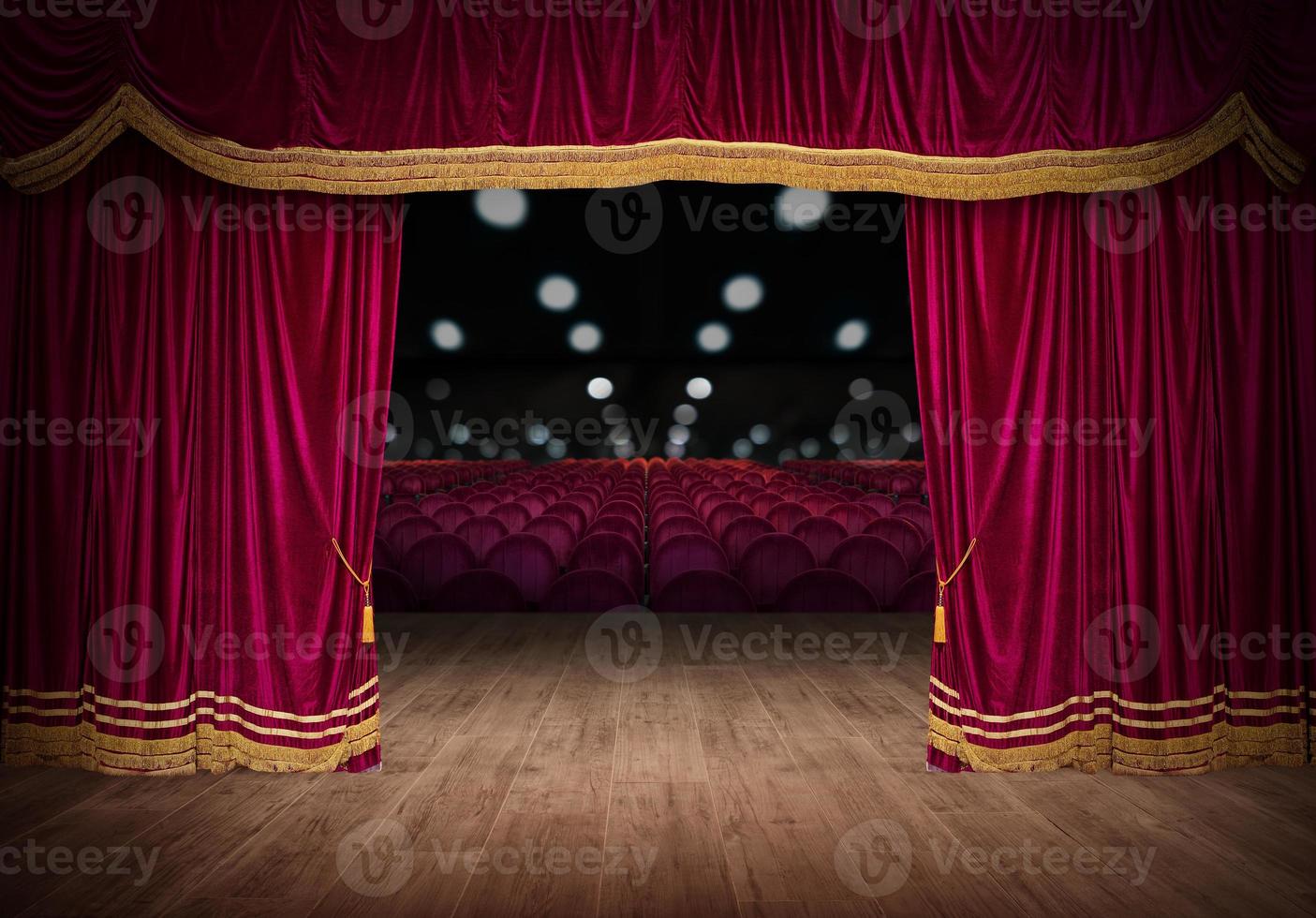 The red curtains are opening for the theater show photo