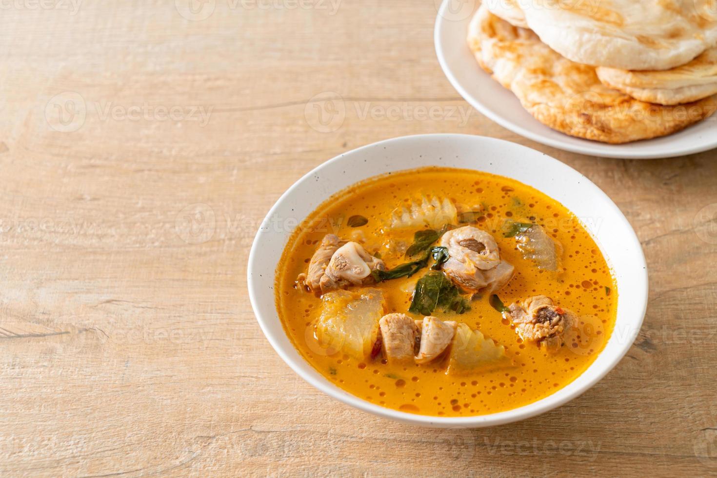 Chicken curry soup with roti photo