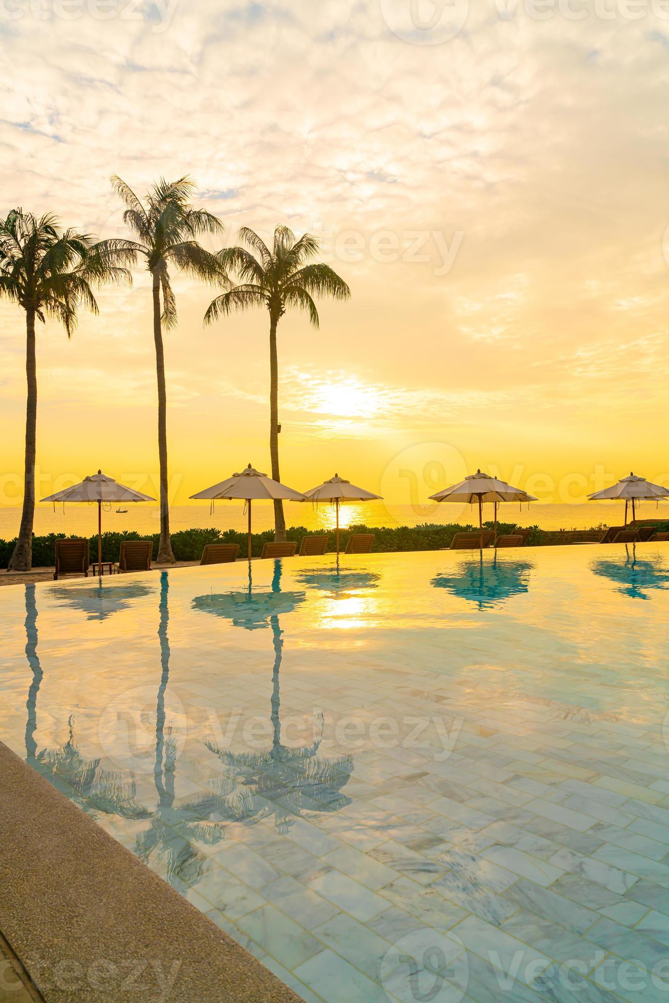 umbrella with bed pool around swimming pool with ocean sea background
