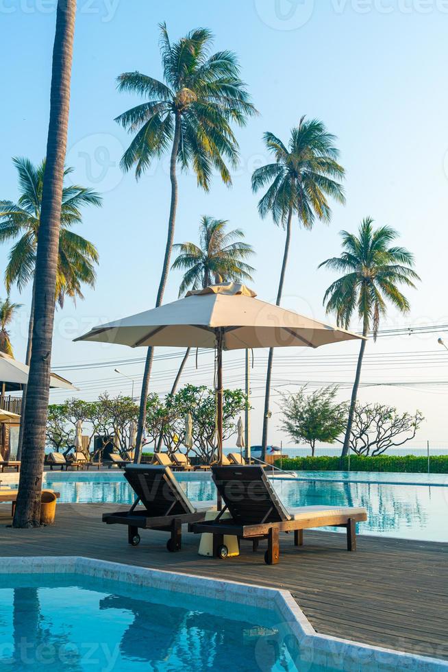 umbrella with bed pool around swimming pool with ocean sea background