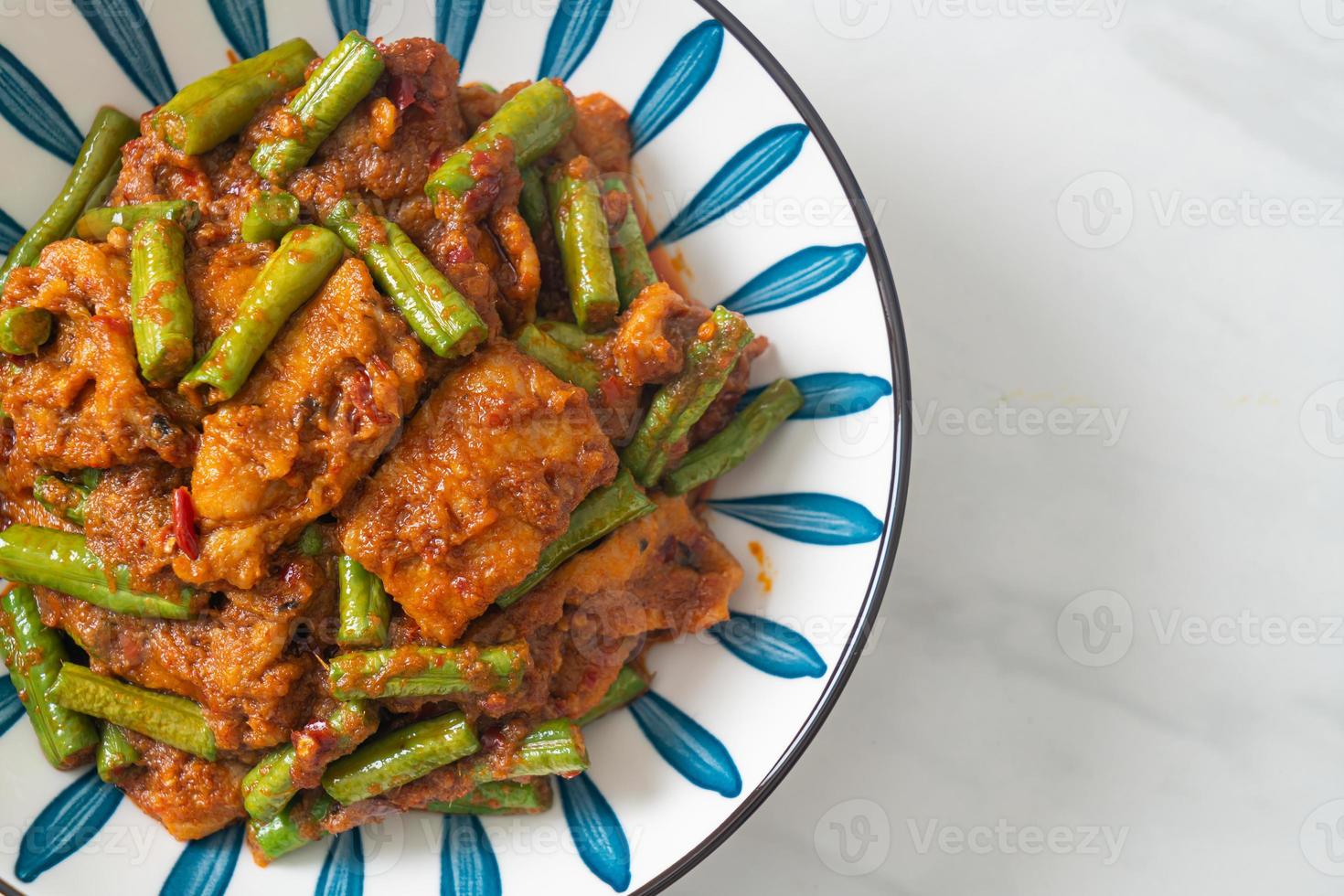 Stir fried pork with red curry paste photo