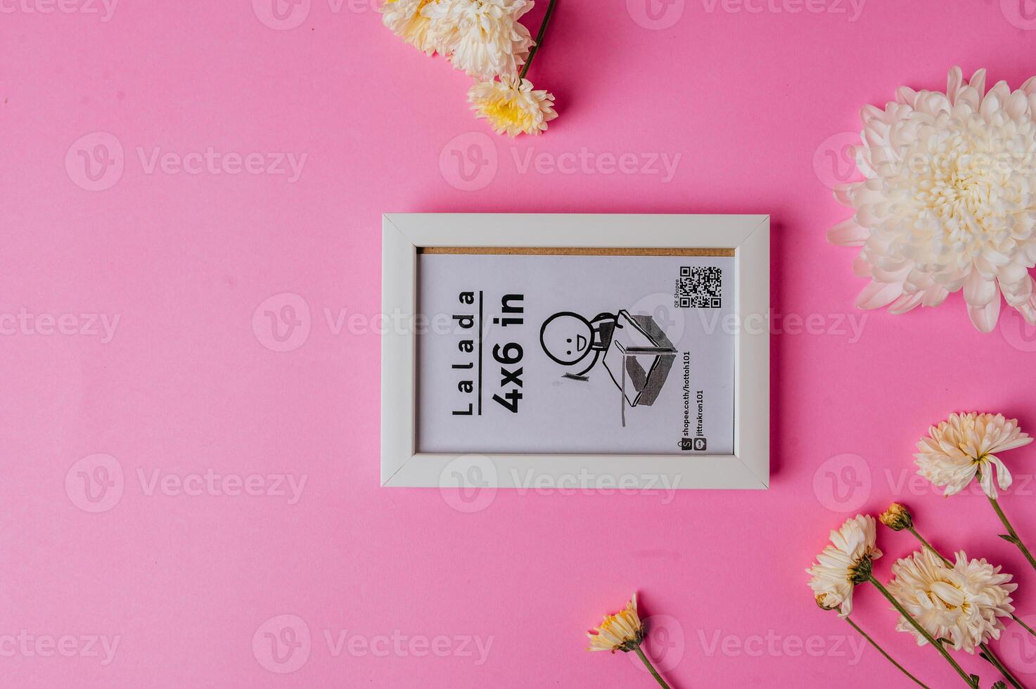 White photo frame with flowers on pink background