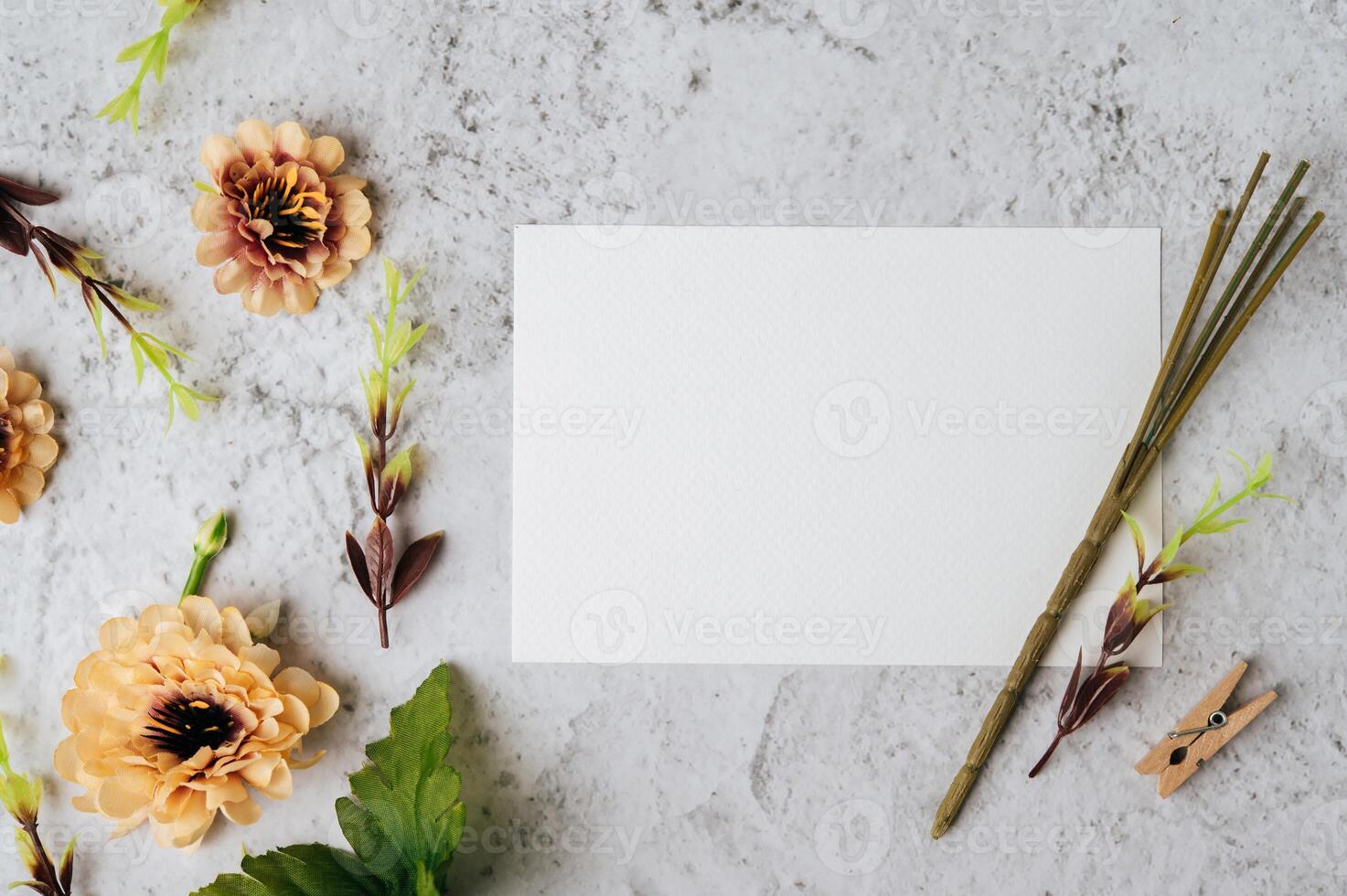 White paper and beautiful flowers on marble background photo