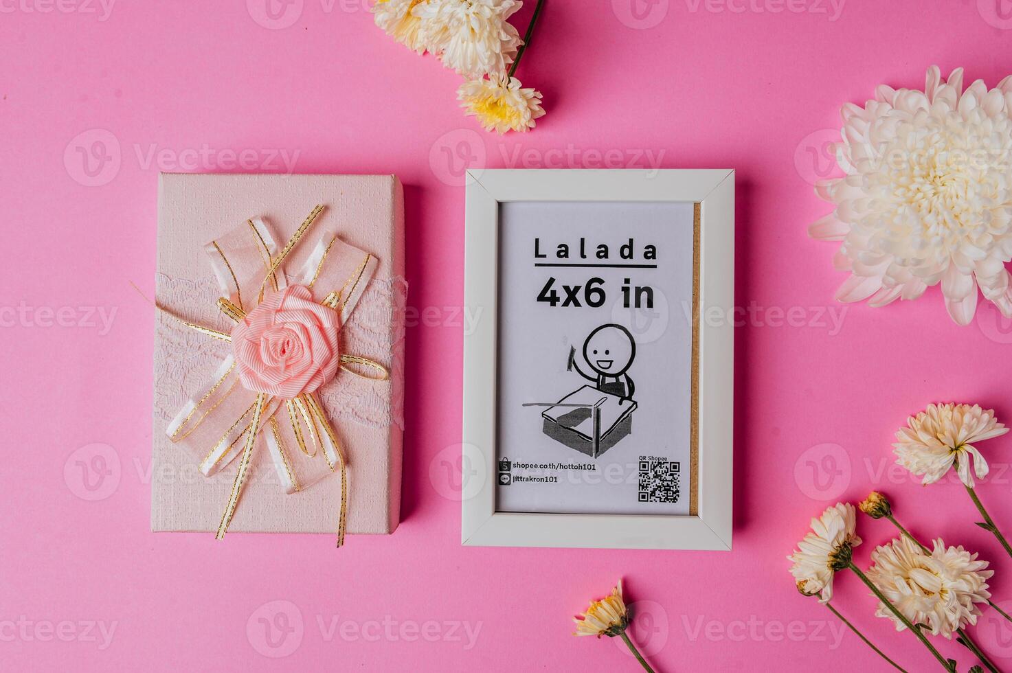 White photo frame with flowers on pink background